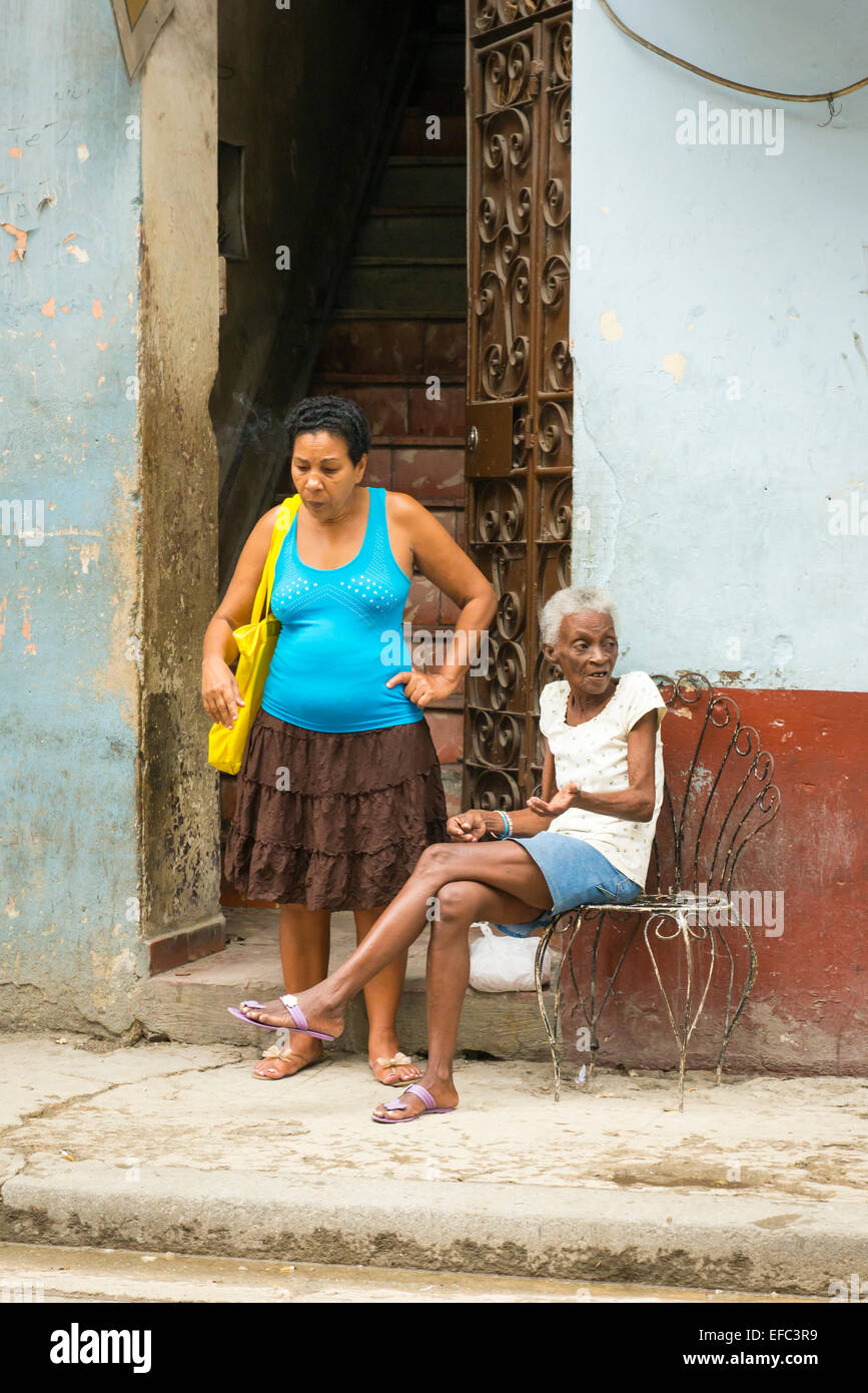 Cuba Old Havana La Habana Vieja street scene 2 two ladies chat chatting pavement Stock Photo