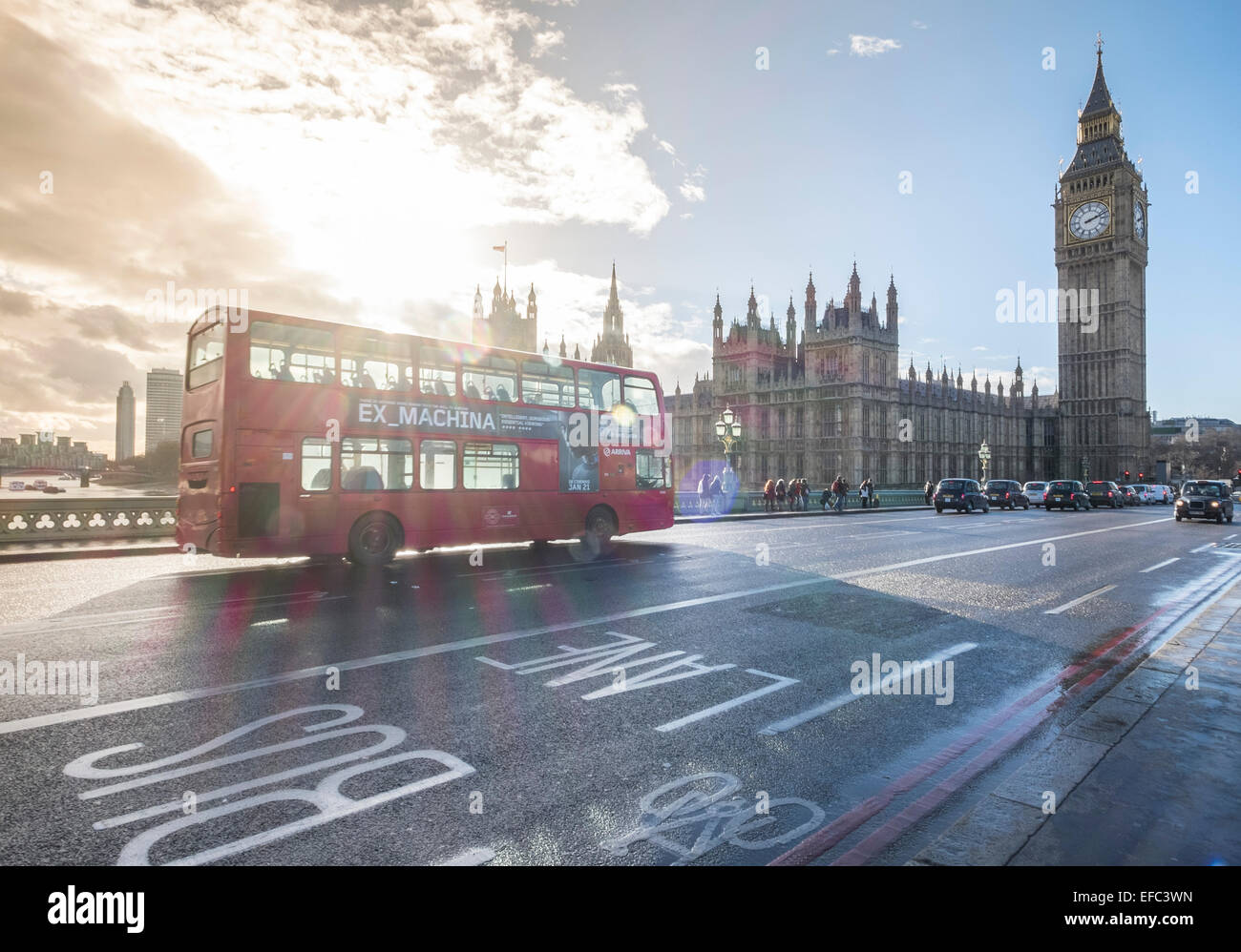 A red London bus on Westminster Bridge, in front of the Houses of Paliament, London, England Stock Photo