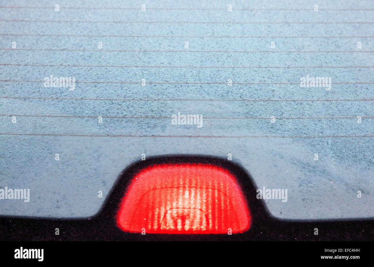 A frosted rear car windscreen windshield and brake light Stock Photo Alamy