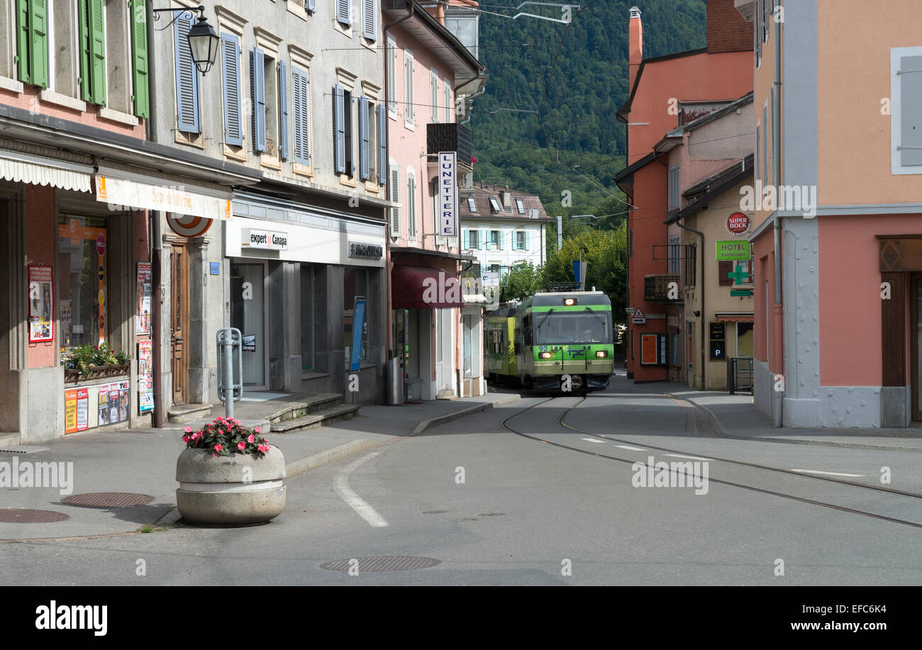 Car 92 passes through the narrow streets of Bex, Switzerland -1 Stock Photo