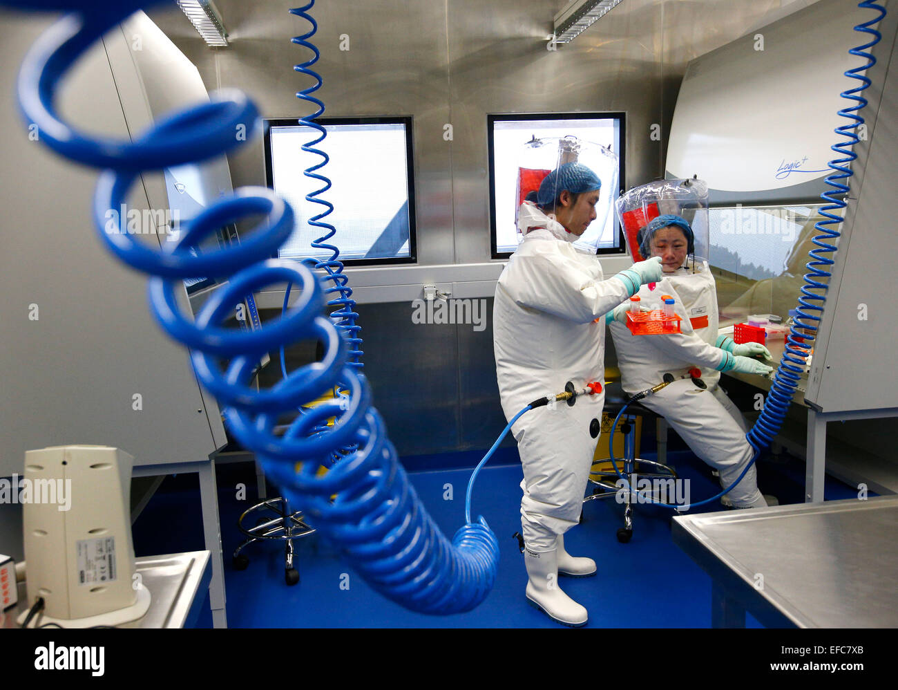 Wuhan, China's Hubei Province. 30th Jan, 2015. Researchers take part in a drill at the newly-completed lab in Wuhan, capital of central China's Hubei Province, Jan. 30, 2015. China completed its first high level biosafety laboratory based in Wuhan Saturday in Wuhan after more than a decade of construction. The lab will be used to study class four pathogens (P4), which refers to the most virulent viruses that pose a high risk of aerosol-transmitted person-to-person infections. © Yin Gang/Xinhua/Alamy Live News Stock Photo