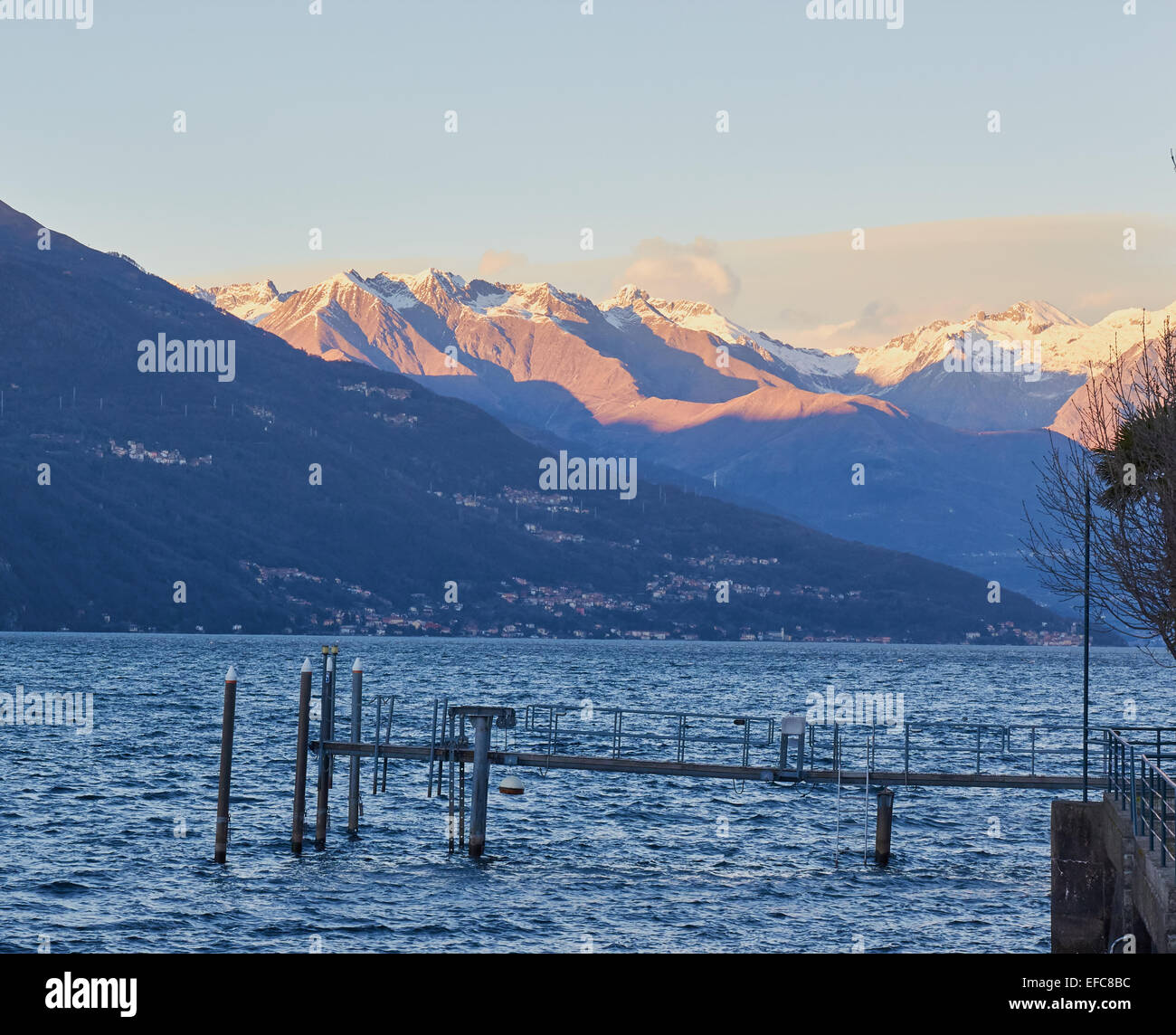 View across Lake Como to the Alps at sunset Lombardy Italy Europe Stock Photo