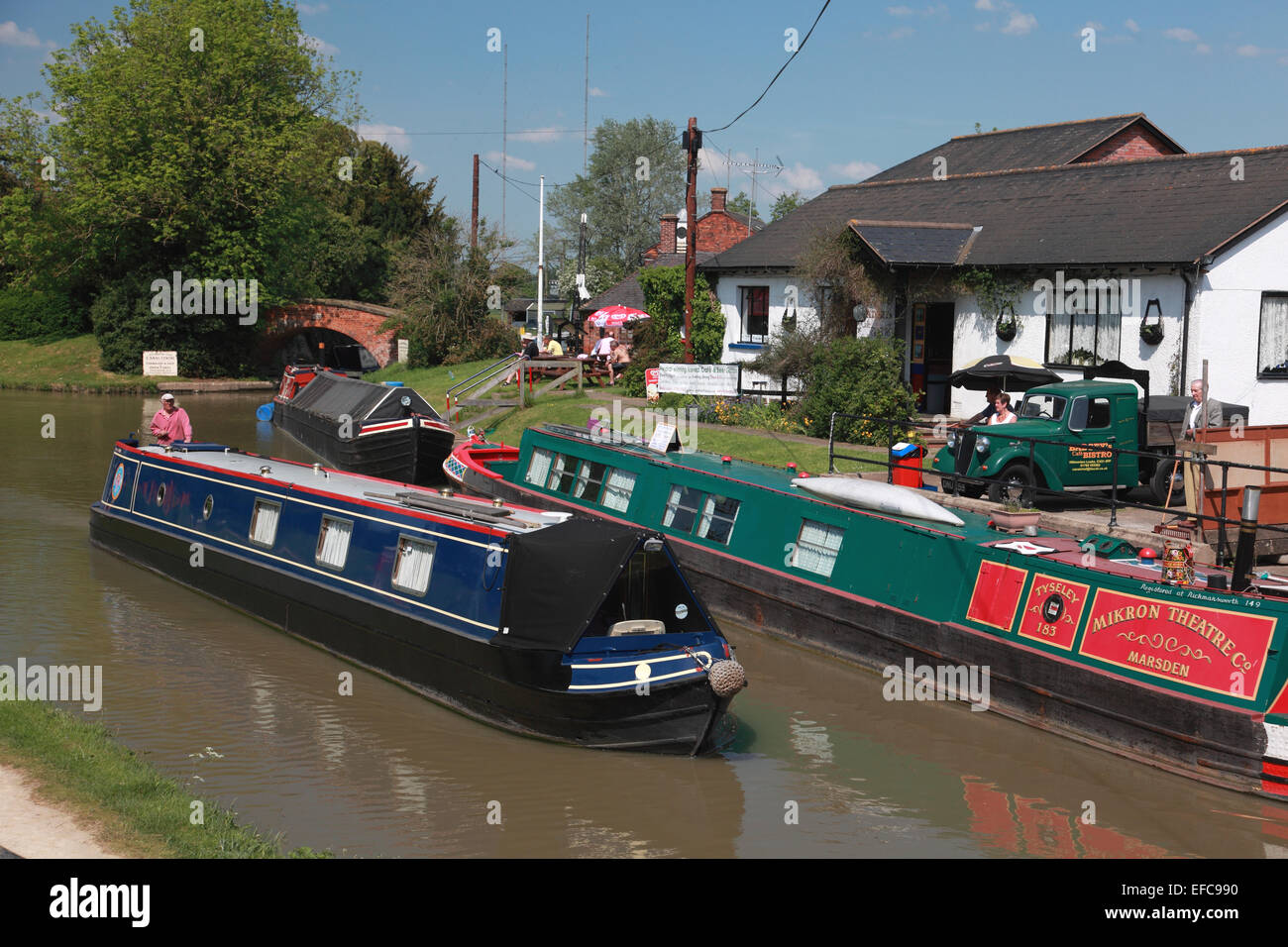 A narrowboat passing Canal Chef Café in the middle of the Hillmorton Lock flight on the Oxford Canal near Rugby, Warwickshire Stock Photo