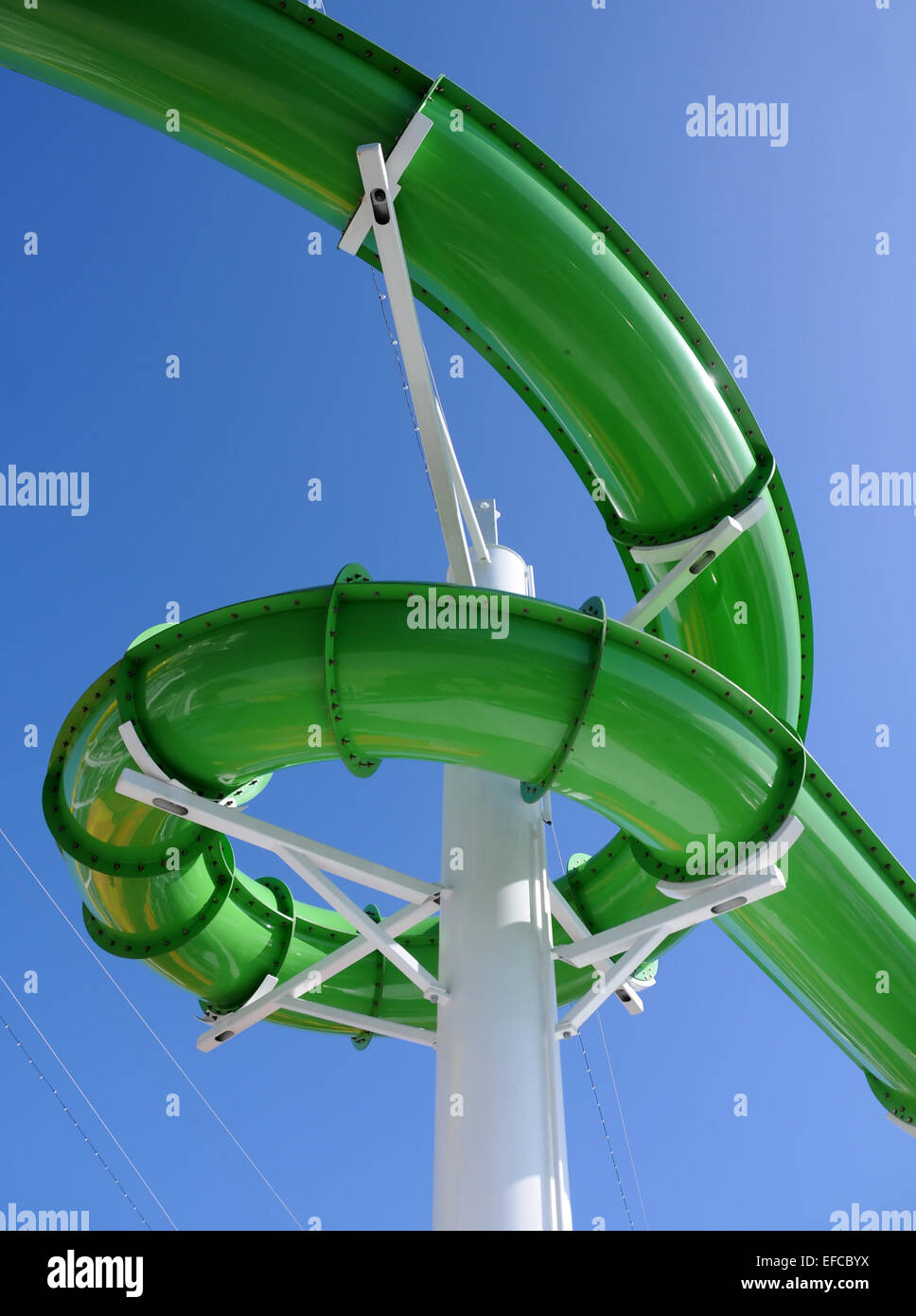 Green water slide at aquatic amusement park Stock Photo - Alamy