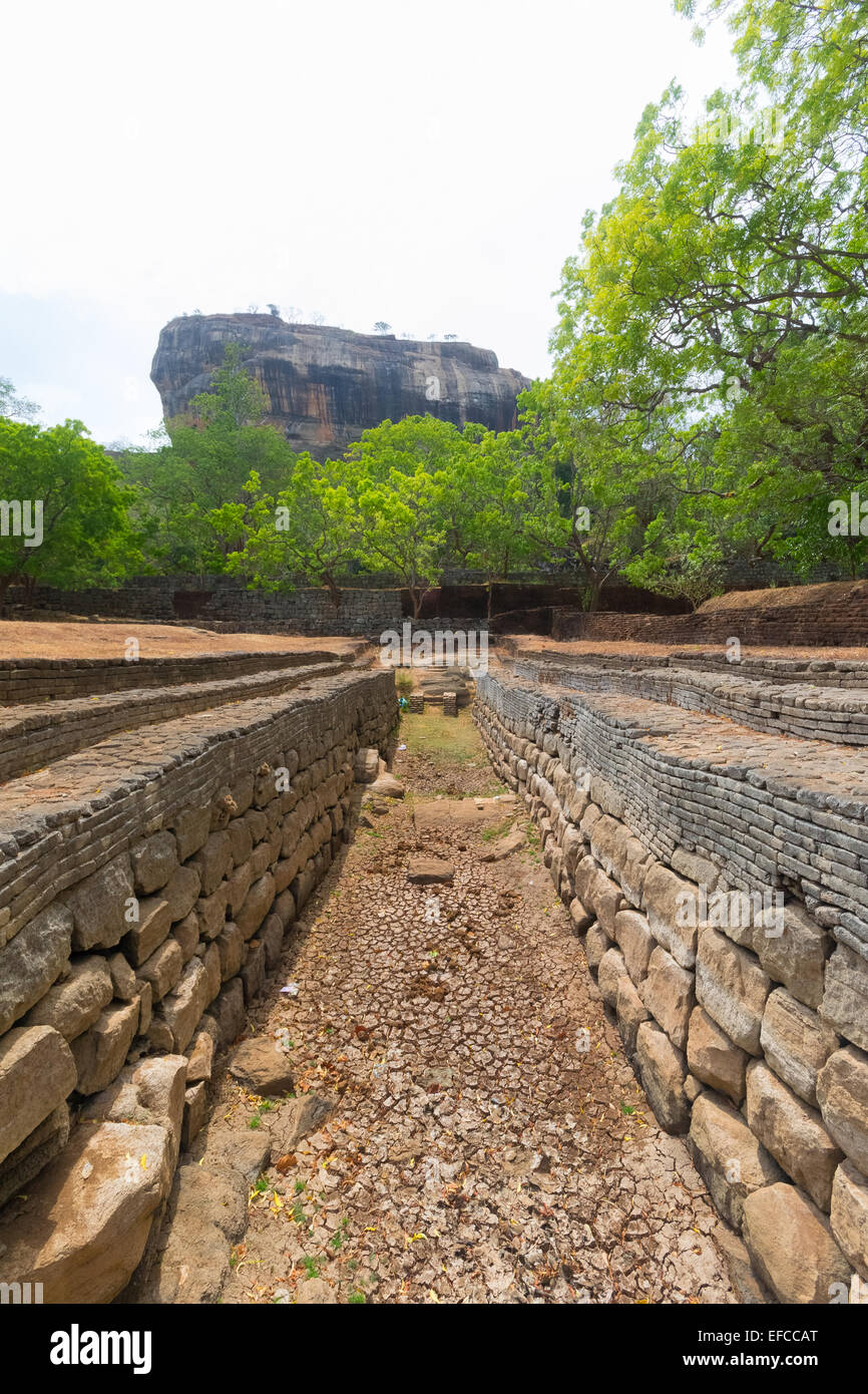 Ancient water channel in direction of the majestic Sigiriya rock, the most important and famous archeological site. Stock Photo