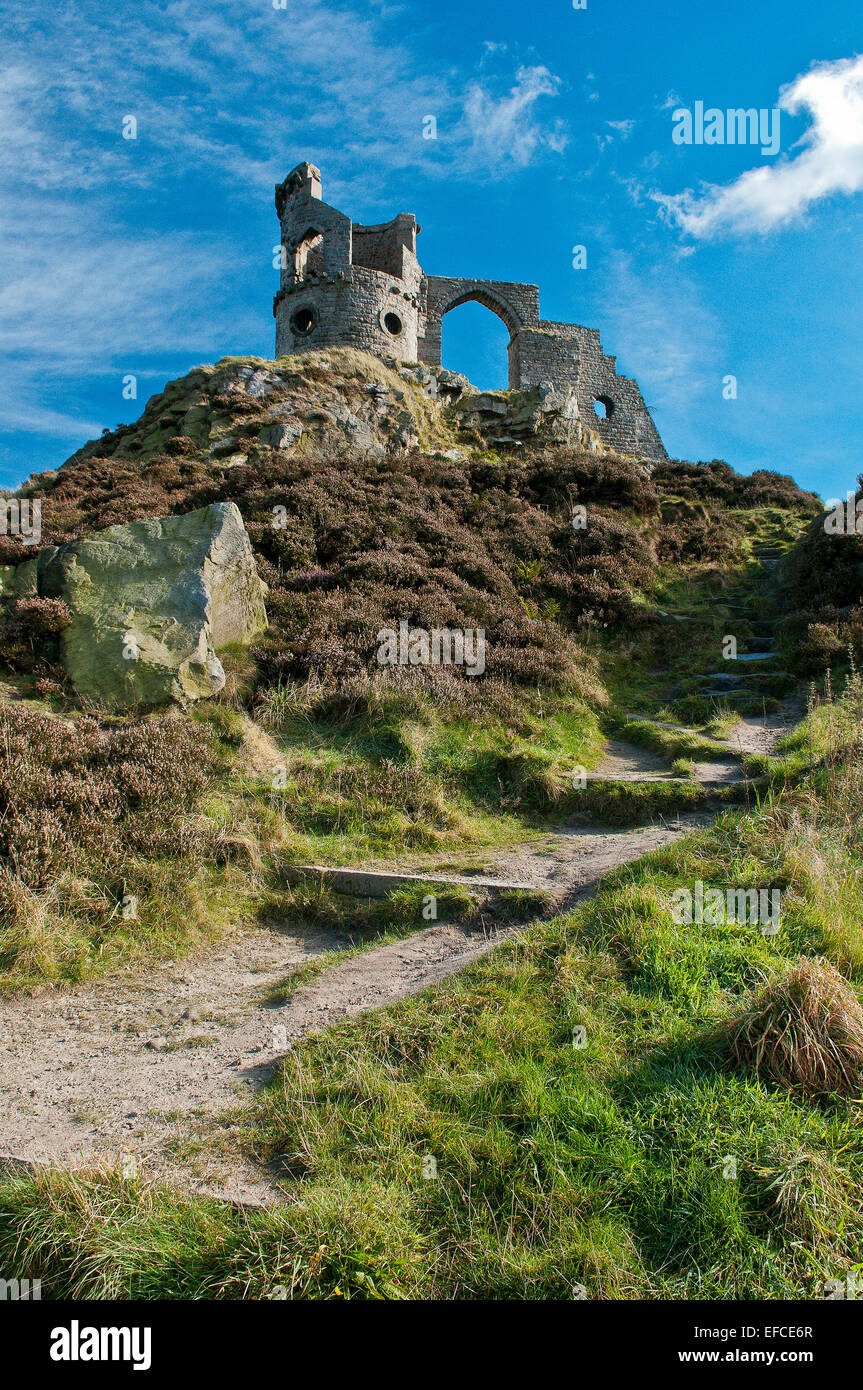 Mow Cop Castle, a folly on the Cheshire-Staffordshire border; steps and path in foreground; blue sky with white clouds. Stock Photo