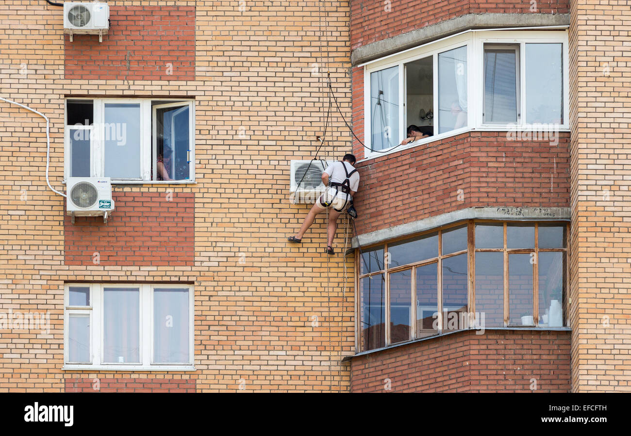 Mounting the air conditioner on the wall of an apartment house Stock Photo