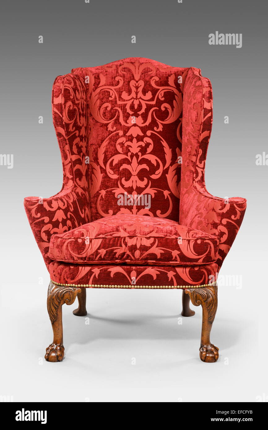 old antique carved red upholstered wing arm chair 18 - 19th century Stock Photo