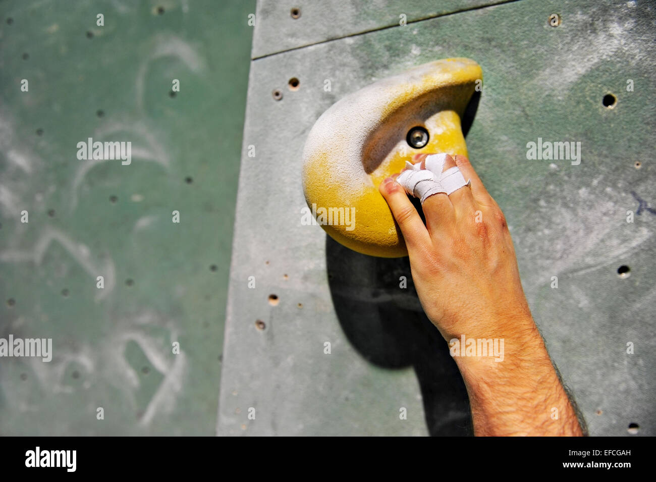 Detail with climber injured hand on artificial indoor climbing wall Stock Photo