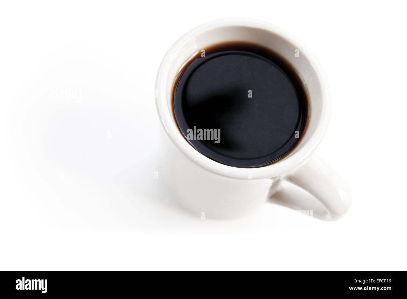 White cup full of black coffee stands on the table with soft shadow Stock Photo