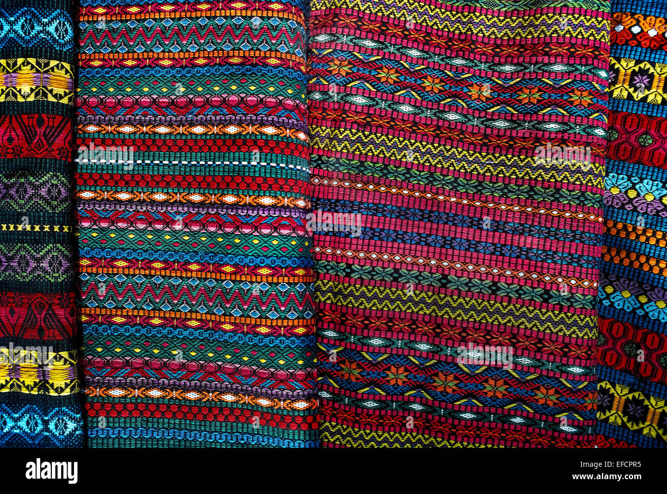 Beautiful colors and intricate geometrical designs identify the fabrics handwoven by Mayan women in the highlands of Guatemala. Stock Photo