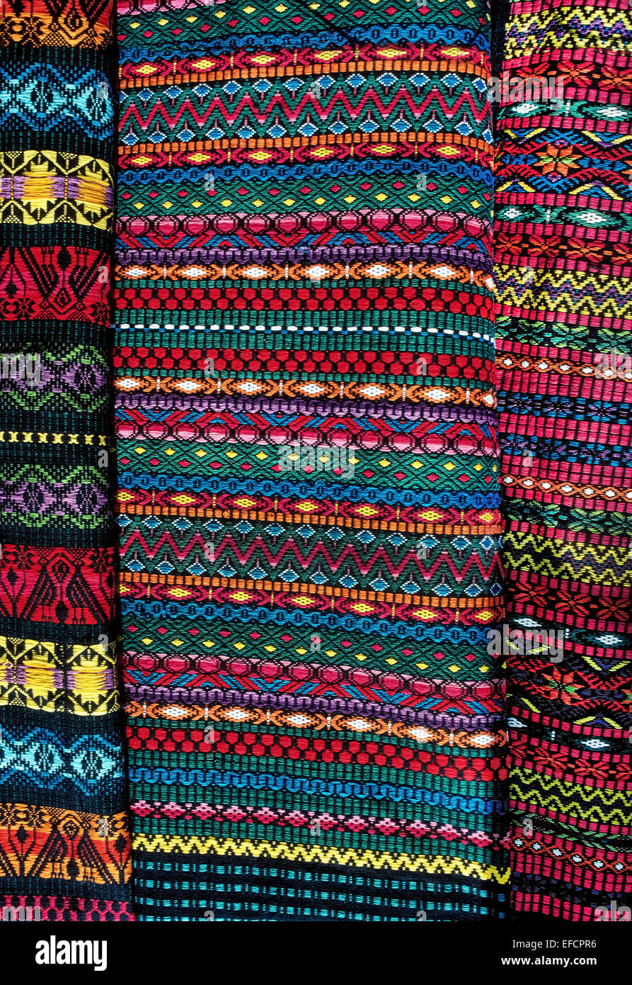 Beautiful colors and intricate geometrical designs identify the fabrics handwoven by Mayan women in the highlands of Guatemala. Stock Photo