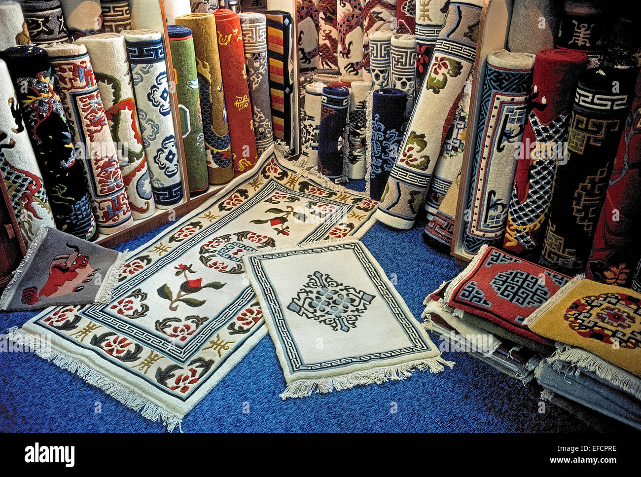 A wide selection of colorful handwoven Tibetan carpets are for sale in rug shops in Kathmandu, capital of Nepal in South Asia. Stock Photo