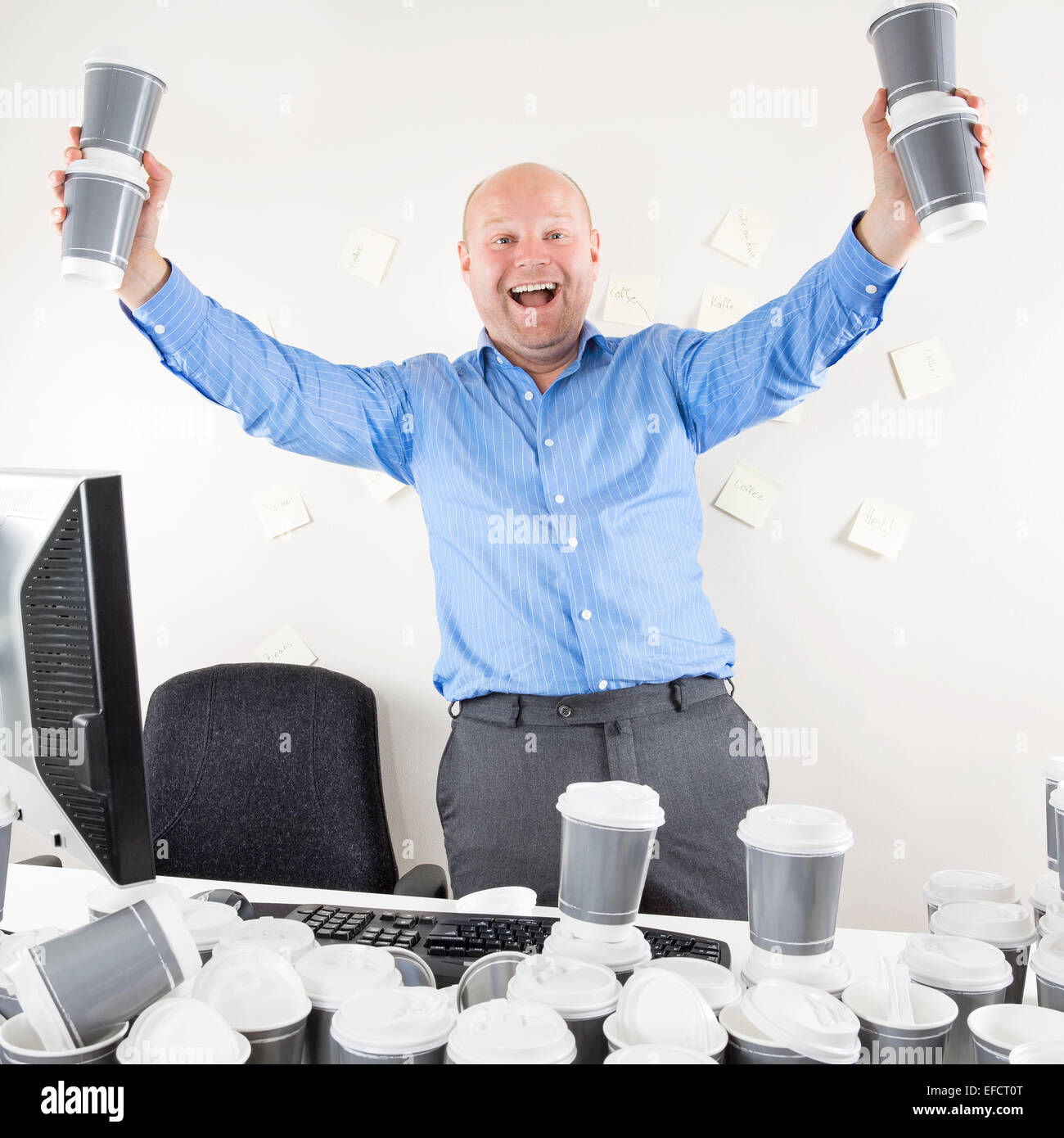Happy and coffee addicted businessman at office Stock Photo