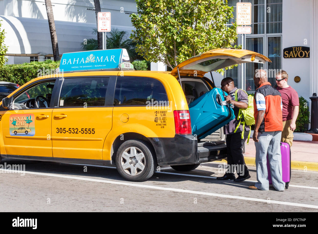 Miami Beach Florida Ocean Drive taxi van Black man driver loading Stock
