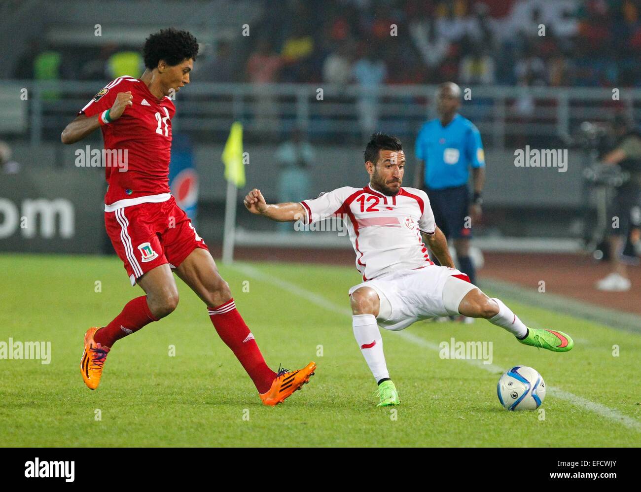 Bata, Equatorial Guinea. 31st Jan, 2015. Ali Maaloul (R) of Tunisia vies for the ball during a quarterfinal match of Africa Cup of Nations between Equatorial Guinea and Tunisia at the Stadium of Bata, Equatorial Guinea, Jan. 31, 2015. Equatorial Guinea won 2-1. Credit:  Li Jing/Xinhua/Alamy Live News Stock Photo