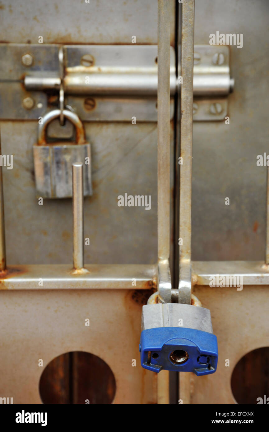 Close-up, detail, two locks securely locking stainless steel security gate and door Still life Illustration Concepts safety risk Stock Photo