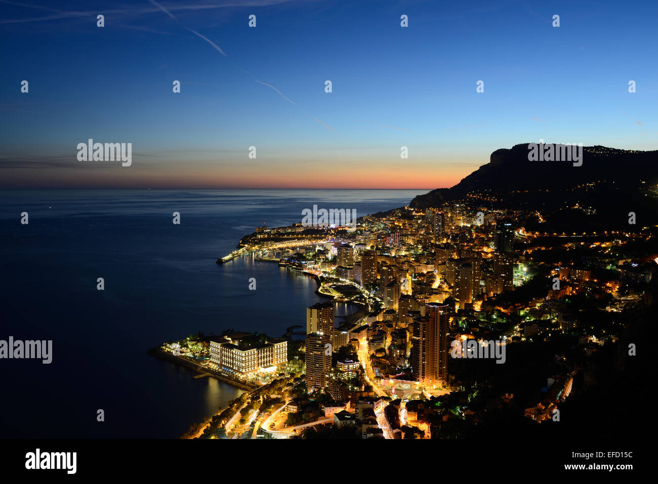 Skyline of the Principality of Monaco at twilight seen from an elevation of 300 meters above sea level. Stock Photo