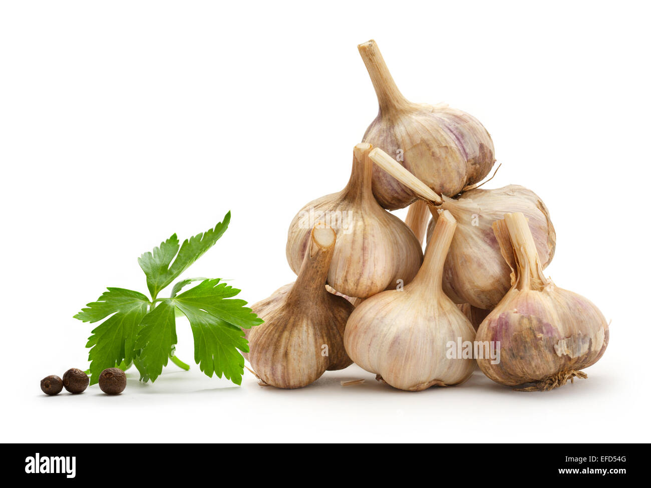 Garlic, parsley and pepper on white background in closeup Stock Photo