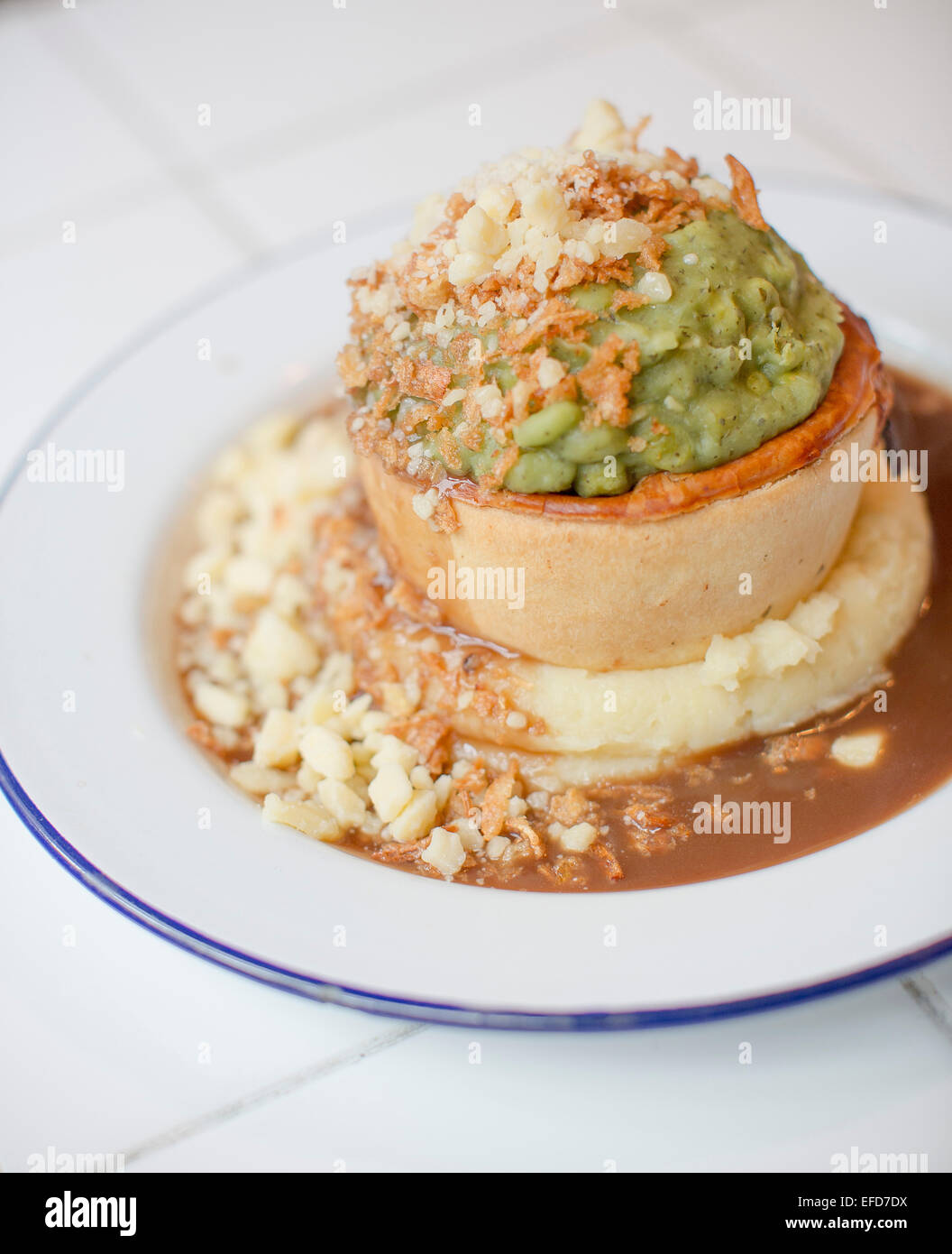 Pieminister pie served with mashed potato, mushy peas, onions and