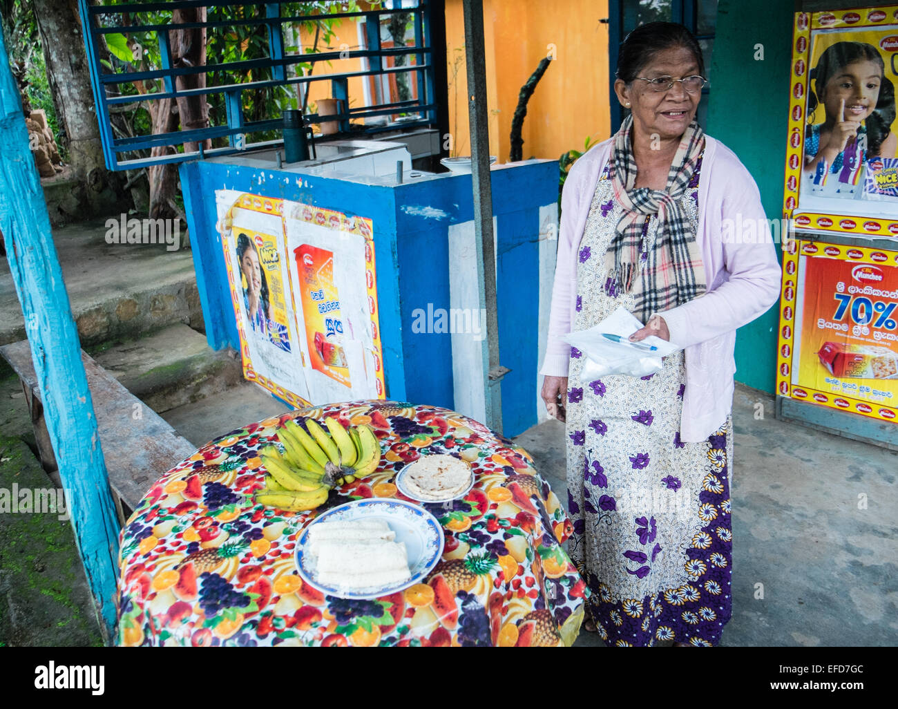 Local woman at her general store shop near train station with breakfast food for train trips at Ella,Highlands,Sri Lanka,Asia. Stock Photo