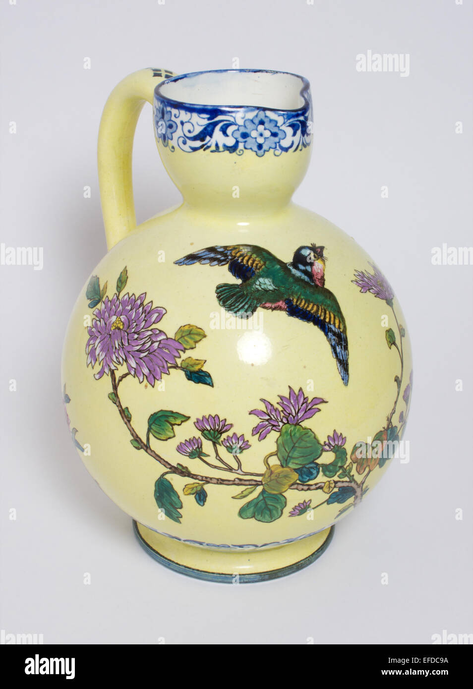 Antique Gien faience pottery bird & dragonfly jug Stock Photo