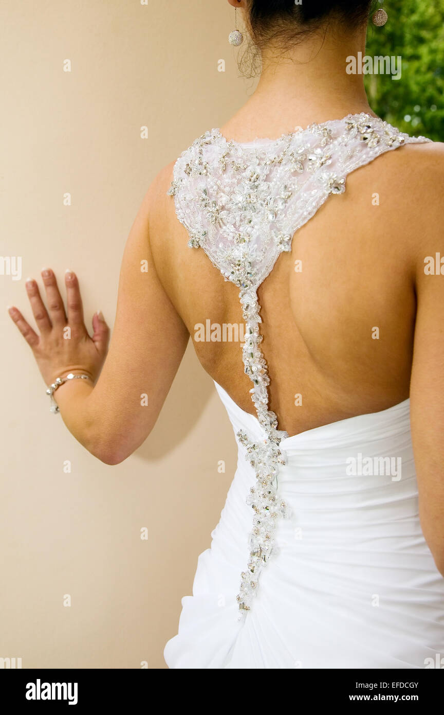 Bride with white dress near the wall Stock Photo