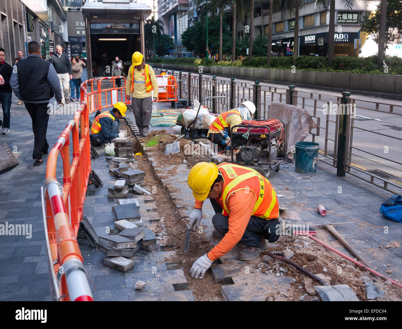 Hong Kong 2015 Workers paving at road construction site Stock Photo