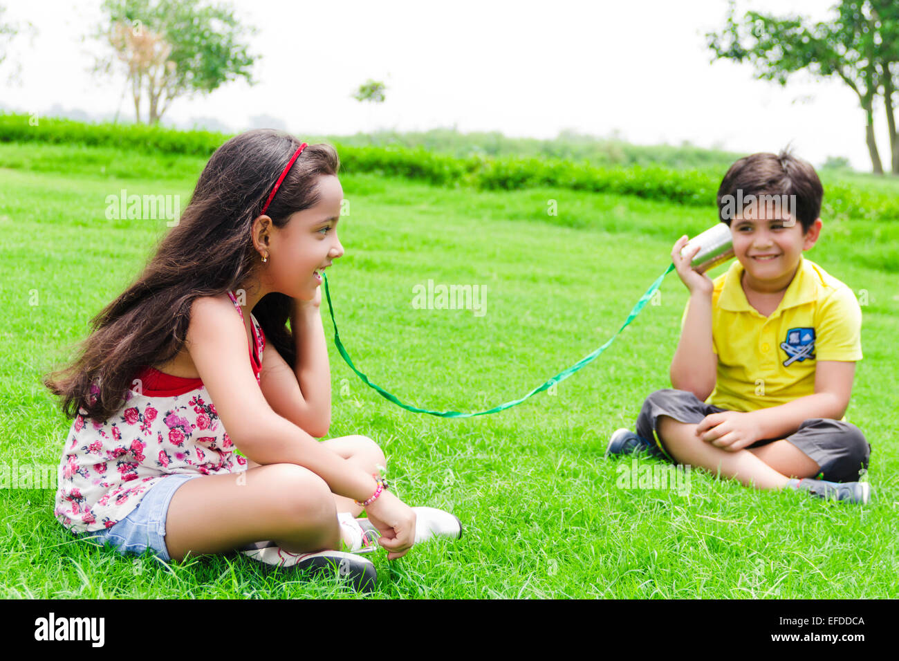 2 indian children friend park toy phone talking Stock Photo