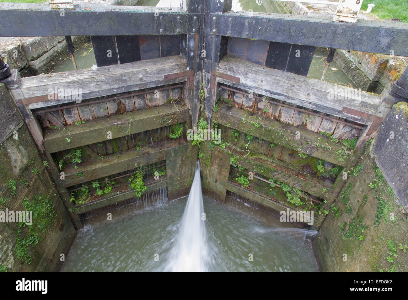 Water spraying through gates of canal lock. Bottom gates of full lock. and Avon Canal