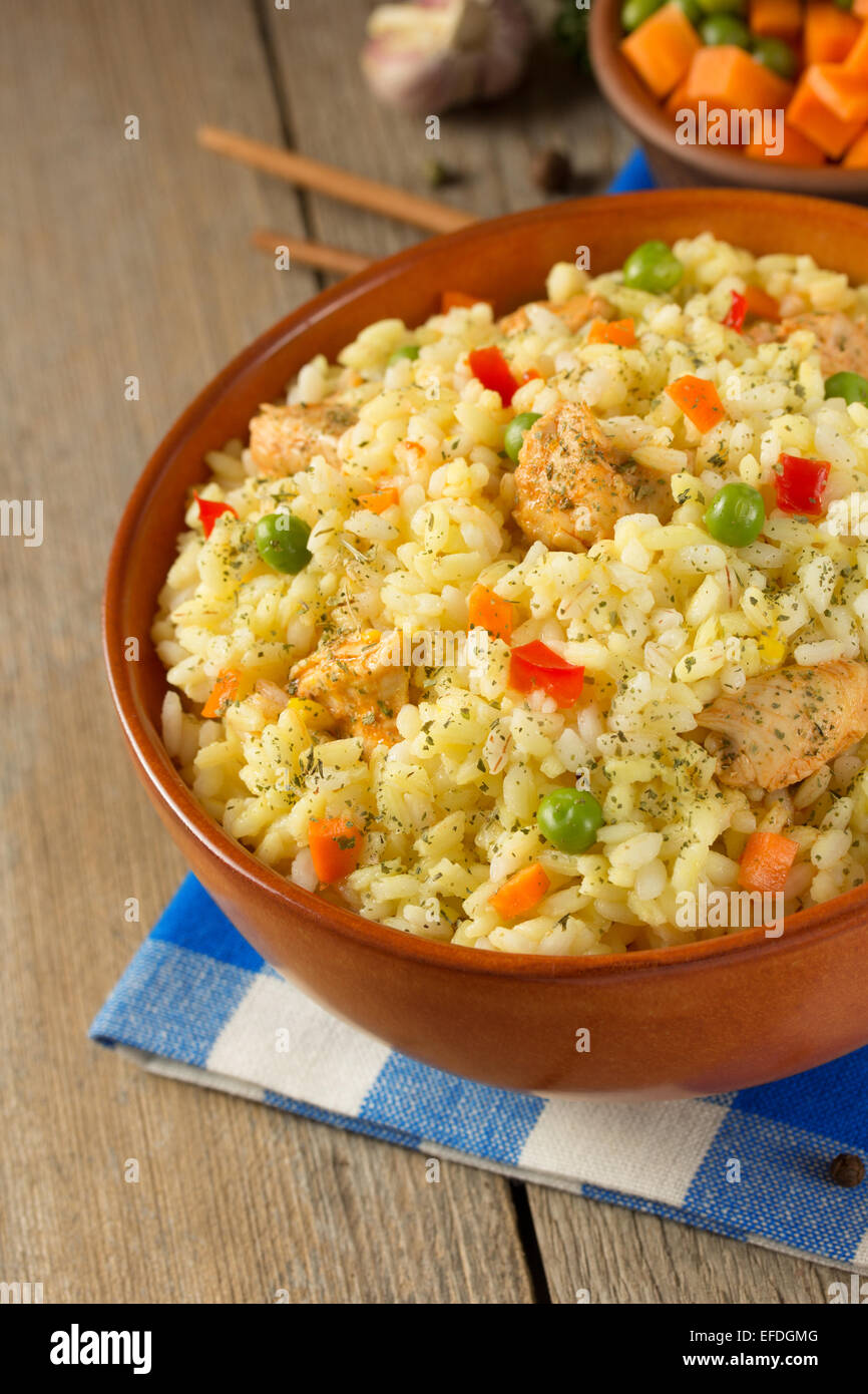 bowl full of rice on wooden background Stock Photo - Alamy