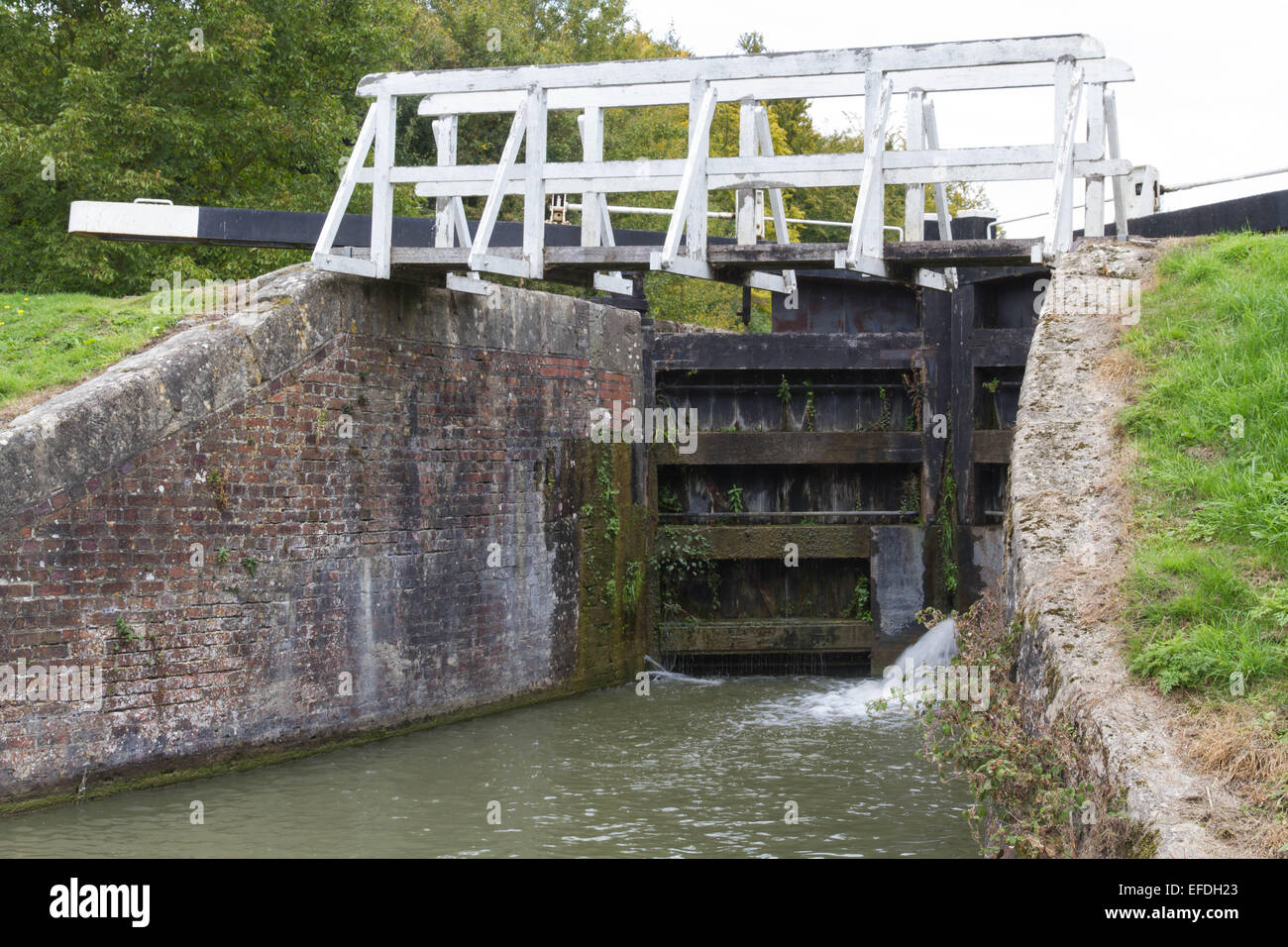 Water spraying through gates of canal lock. Bottom gates of full lock. and Avon Canal