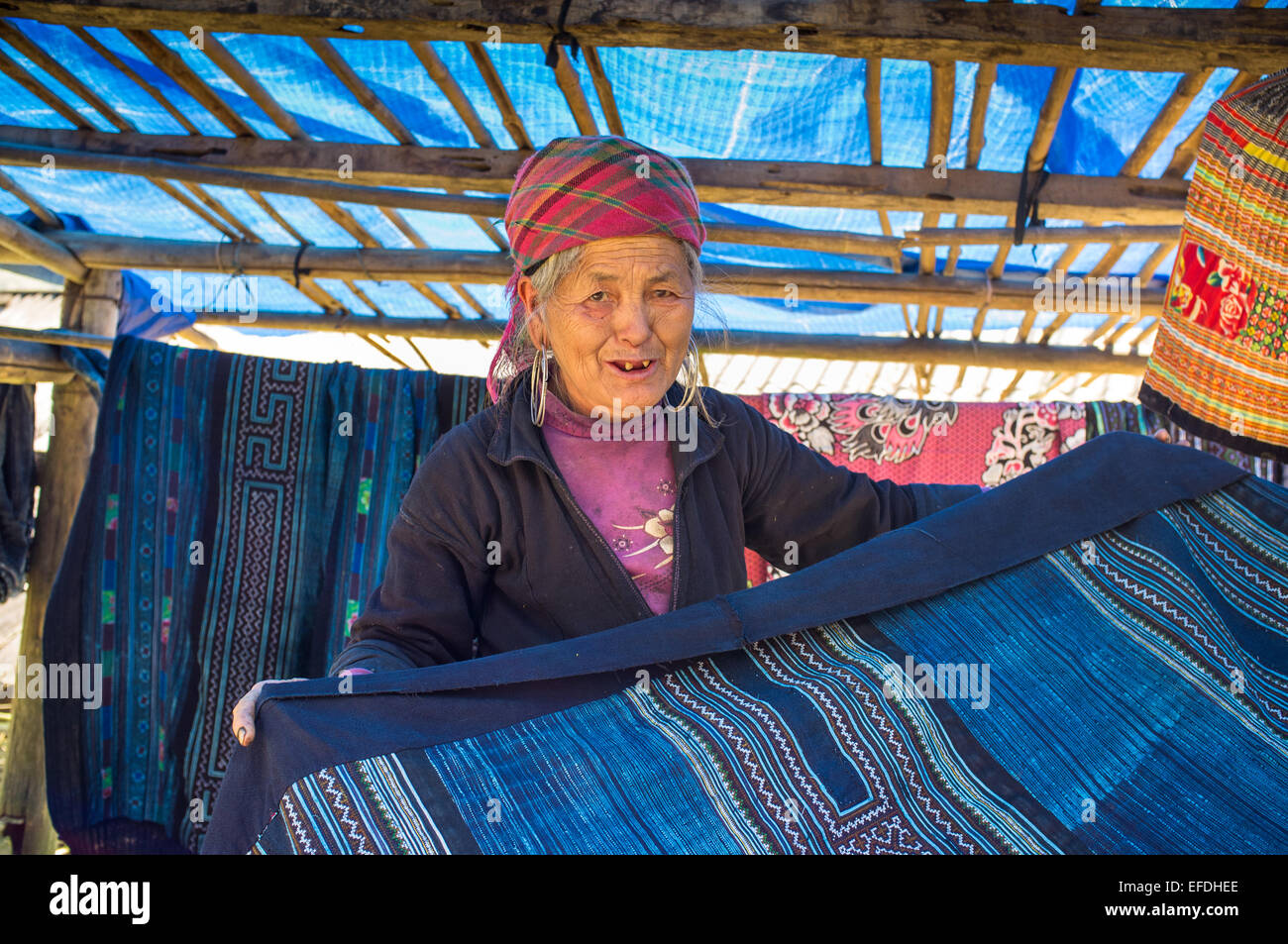 Hmong woman with indigo clothes on sale, Sapa hill tribe region, Northern Vietnam, Asia Stock Photo