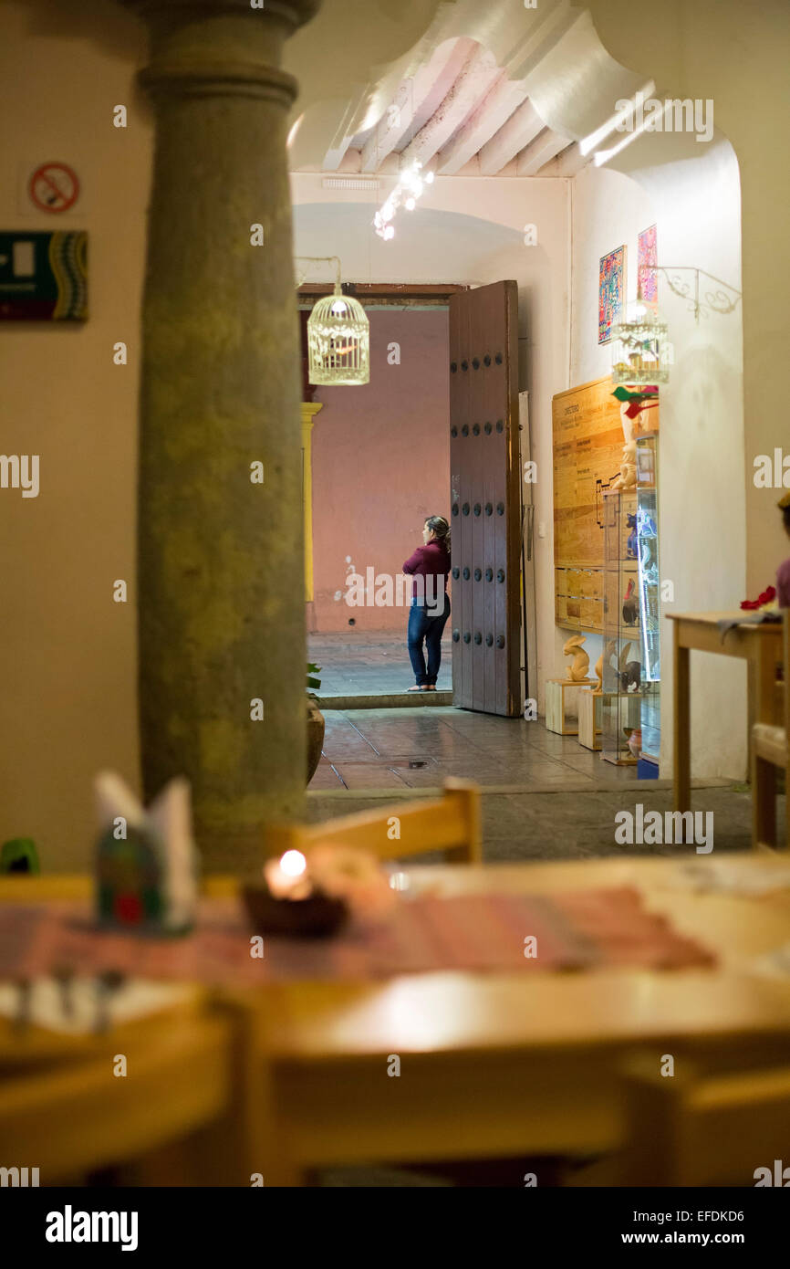 Oaxaca, Mexico - A woman waits for customers at the door of a restaurant. Stock Photo