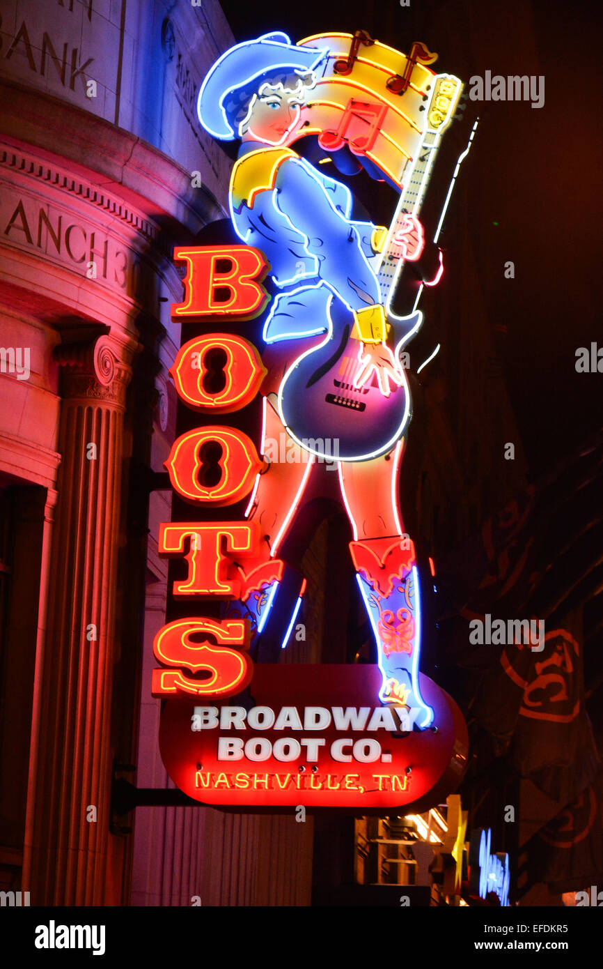 The huge and colorful Neon Cowgirl with guitar, lights up lower Broadway for Broadway Boot Co. in Nashville, TN Stock Photo