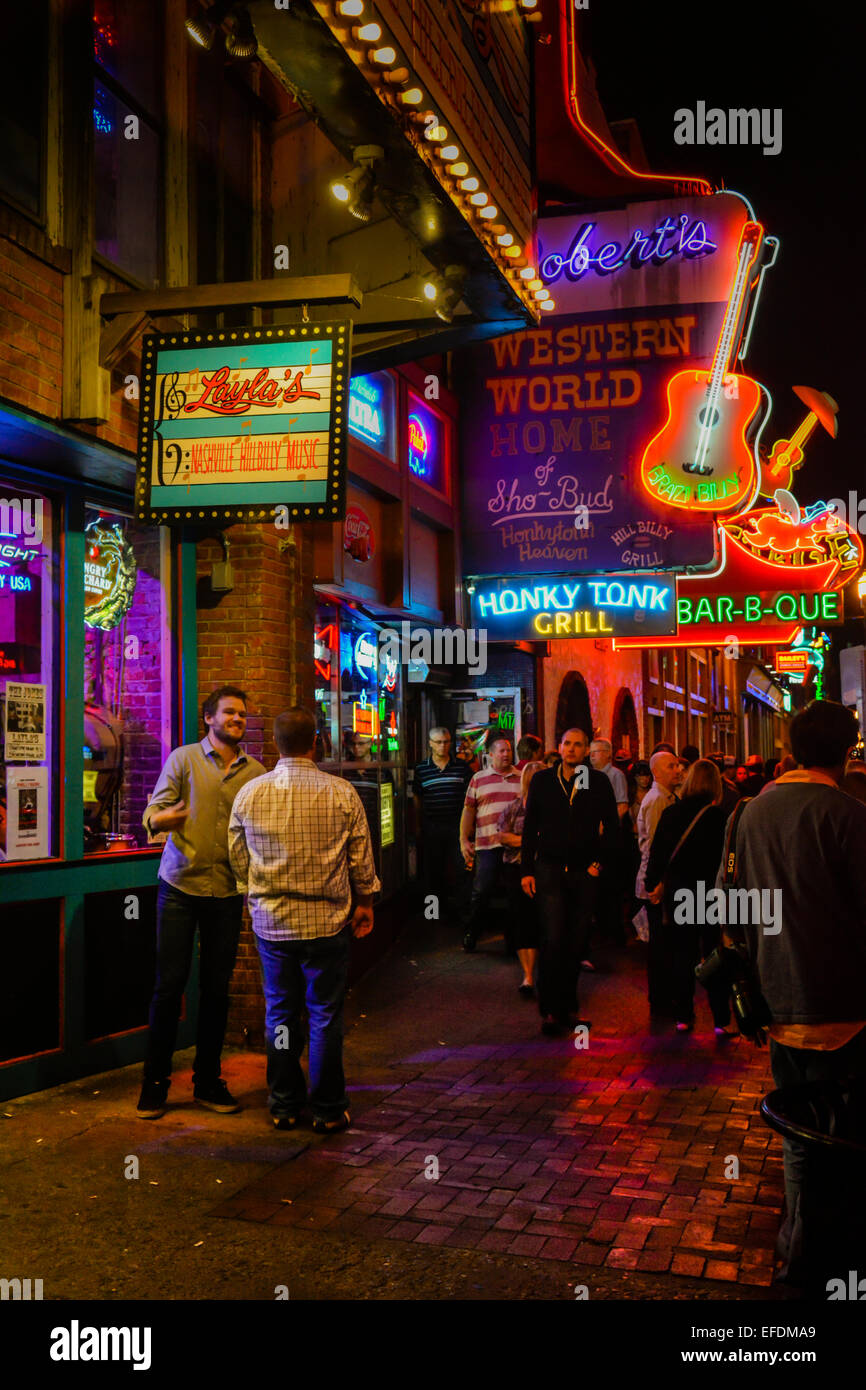 Nighttime Neon lights up lower Broadway for tourists cruising the music entertainment district in downtown Nashville TN Stock Photo