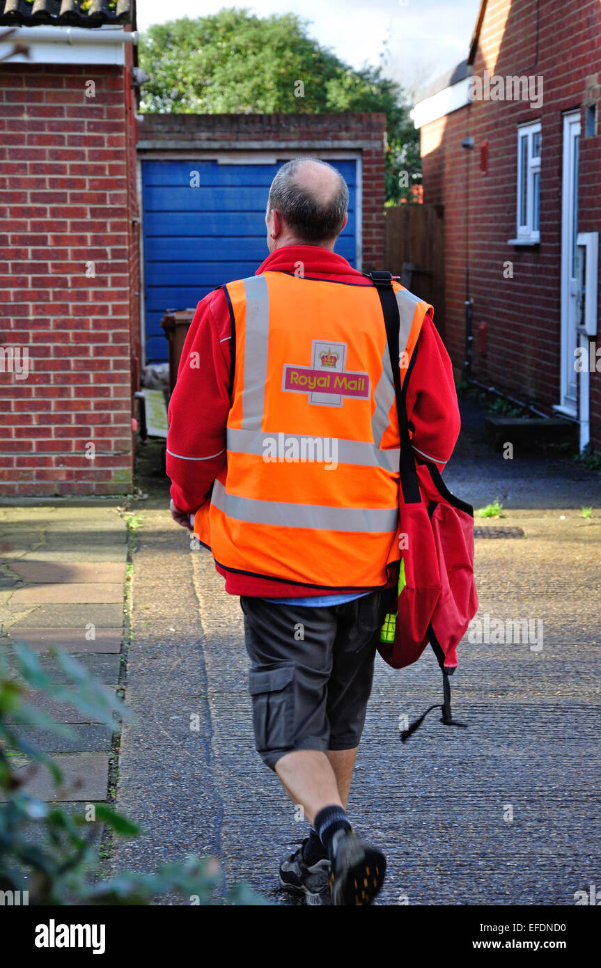 Royal Mail postman delivering mail, Stanwell Moor, Surrey, England, United Kingdom Stock Photo