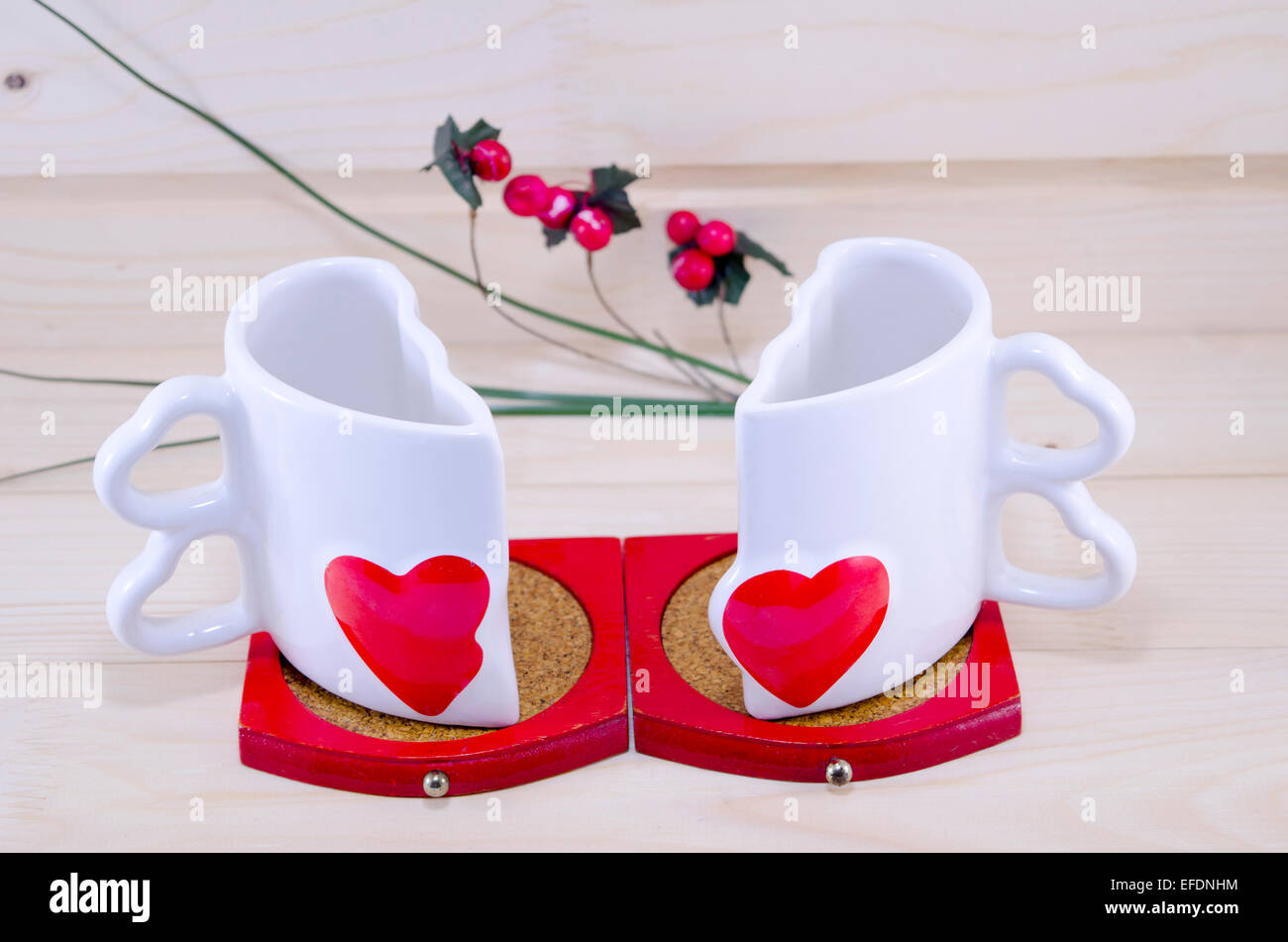 Unique heart shaped coffee mug split apart on a wooden table Stock Photo