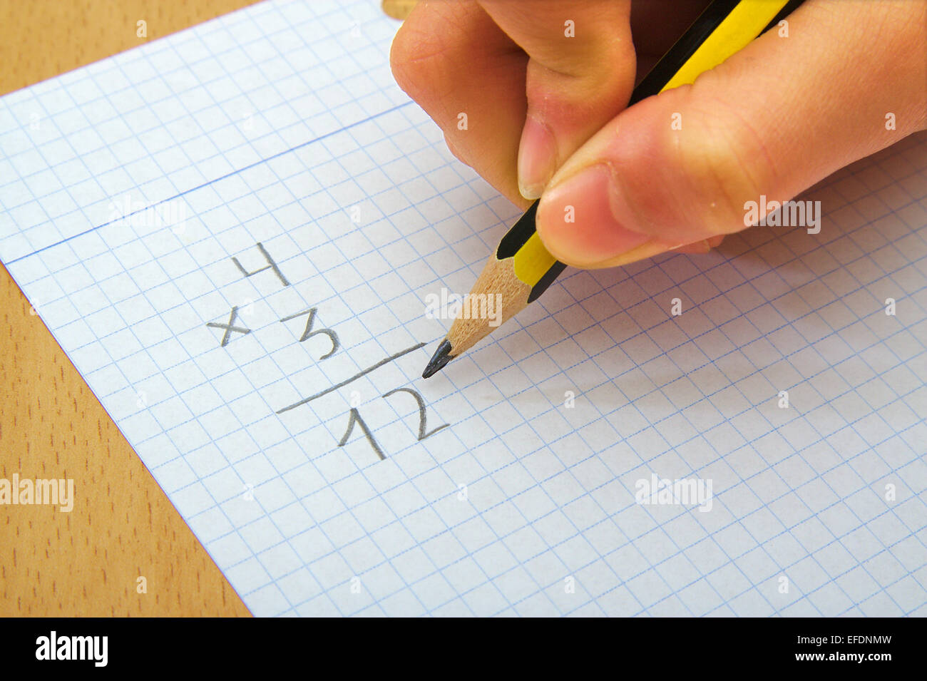 Closeup on the hands of a child doing maths. Multiply. School concept ...
