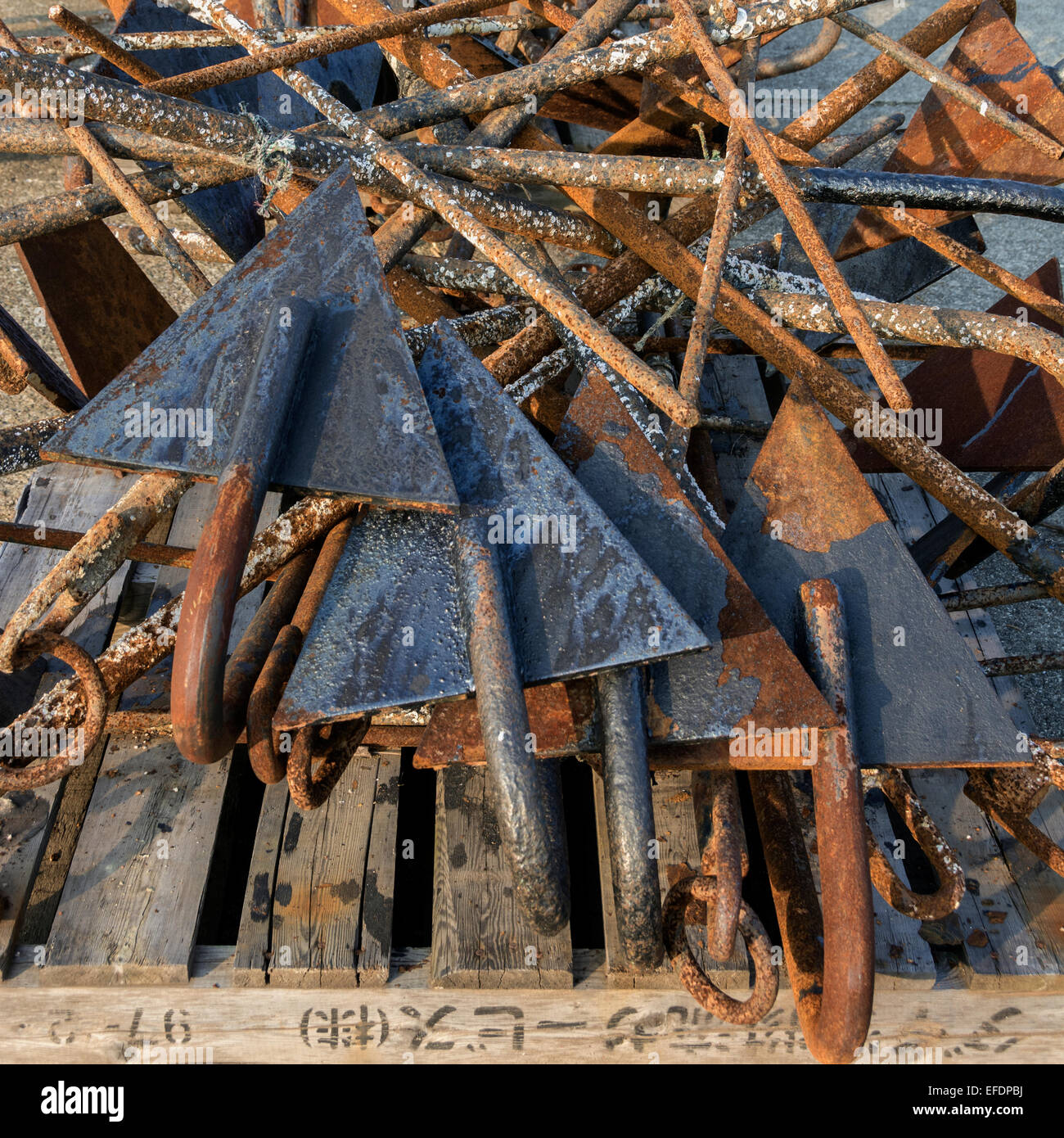 Pile of rusted, barnacle-encrusted anchors, Naruto Harbor, Shikoku Island, Japan Stock Photo