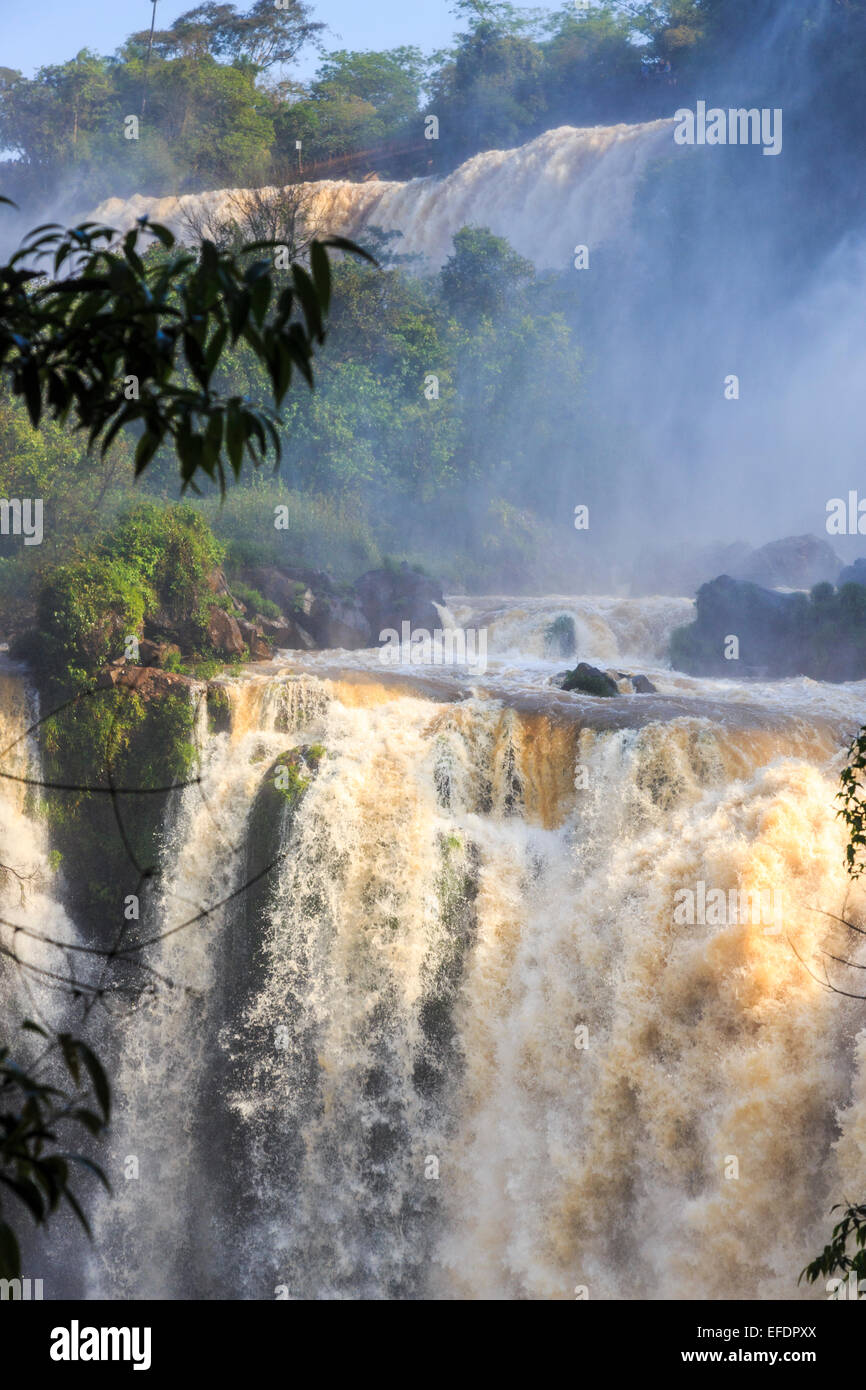 Natural wonders: View of the magnificent huge Iguazu Falls in full spate, viewed from the Argentinian side on a sunny day with blue sky Stock Photo