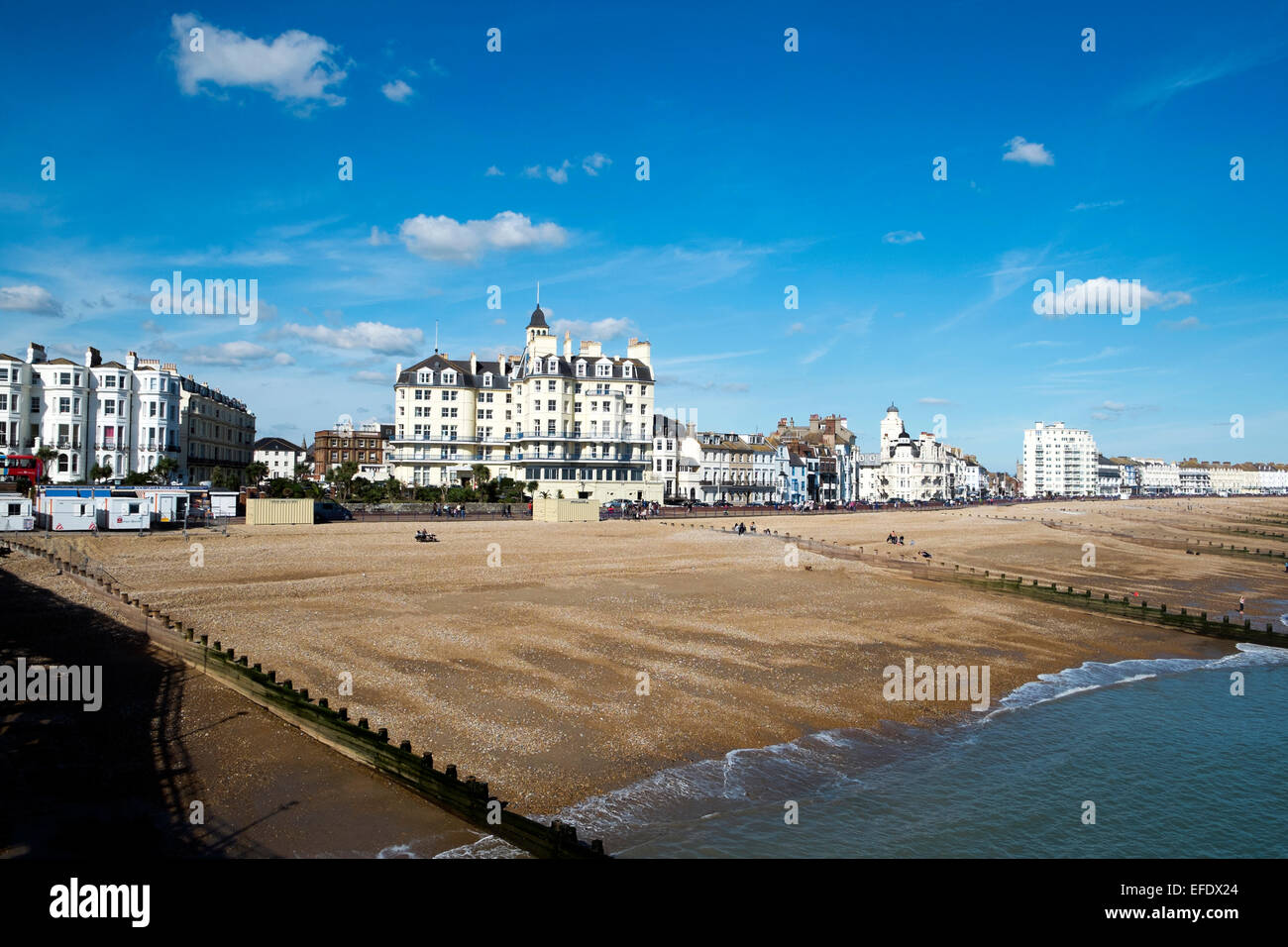 A view from Eastbourne Pier of the shingle beach and coastal buildings. Stock Photo