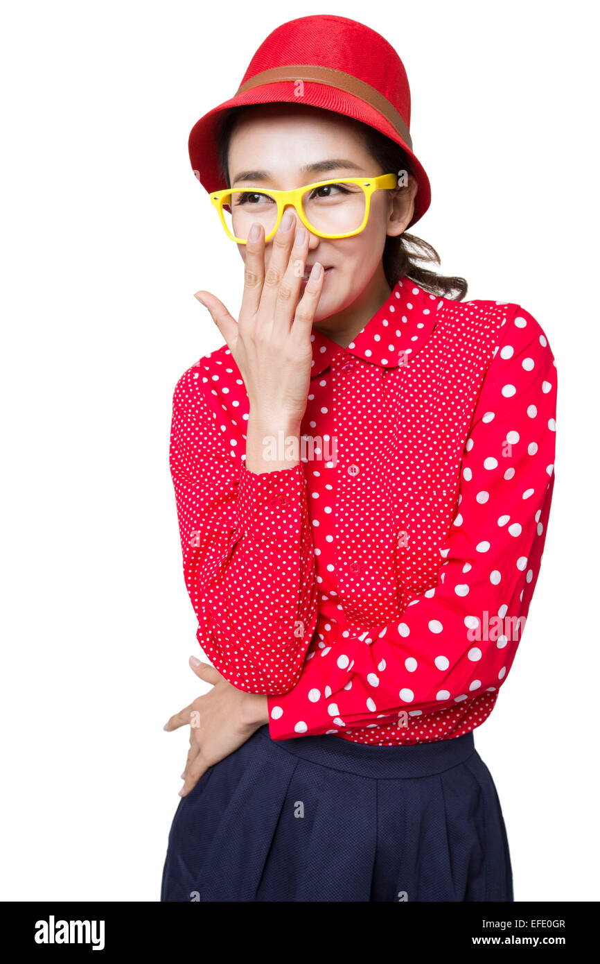 Young woman covering mouth laughing Stock Photo