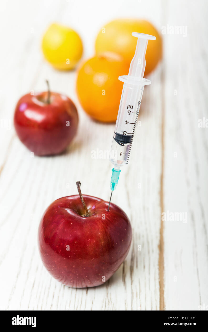 Injection into red apple Stock Photo - Alamy