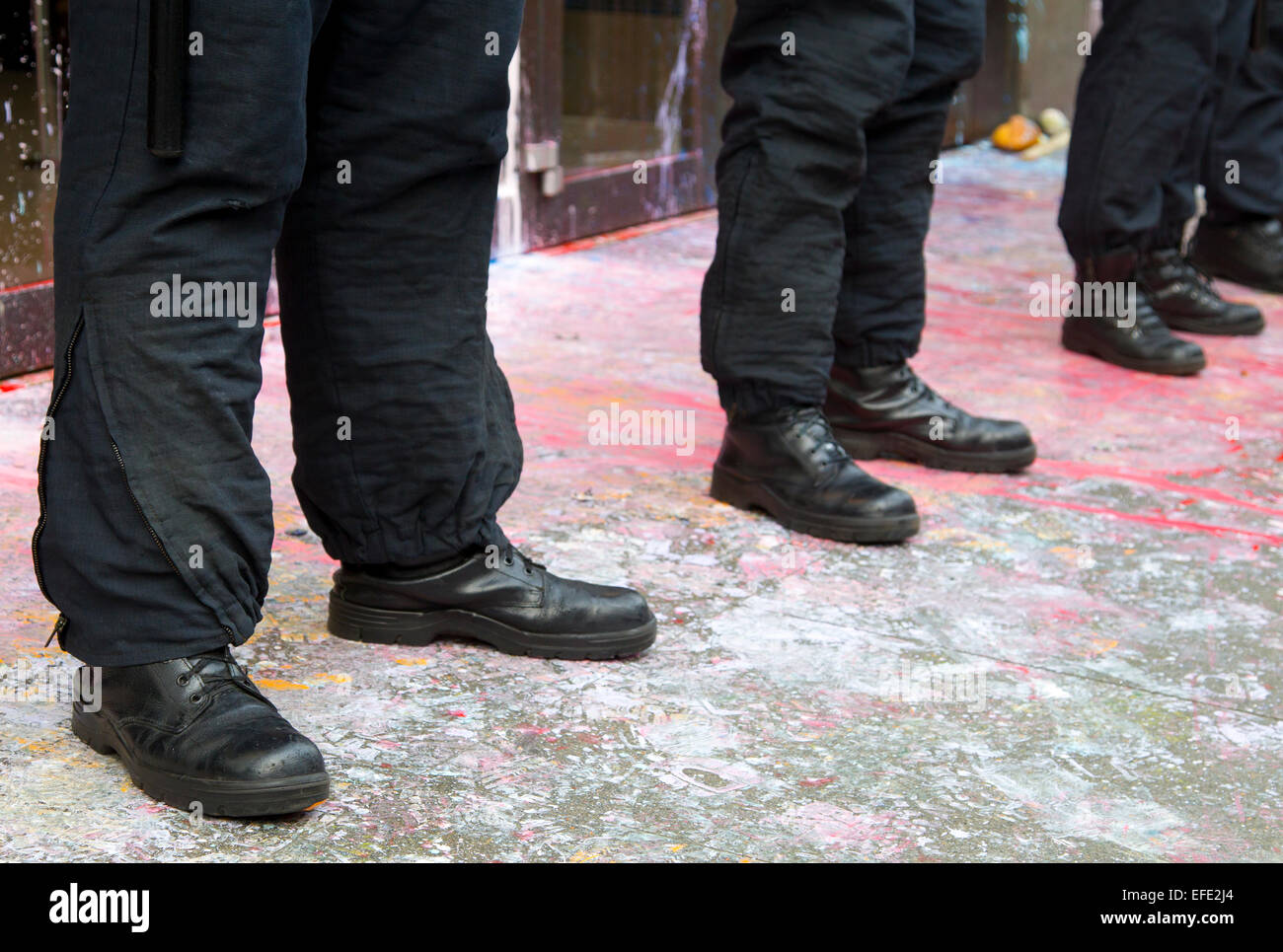 Police officer's boots and trousers.  Officers are guarding Top Shop, Oxford Street during 2011 tax avoidance protest. Stock Photo