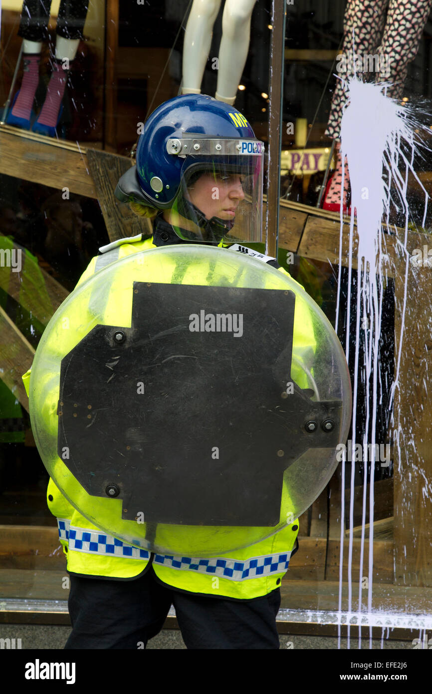 Female police officer in riot gear at Top Shop store in Oxford Street ...