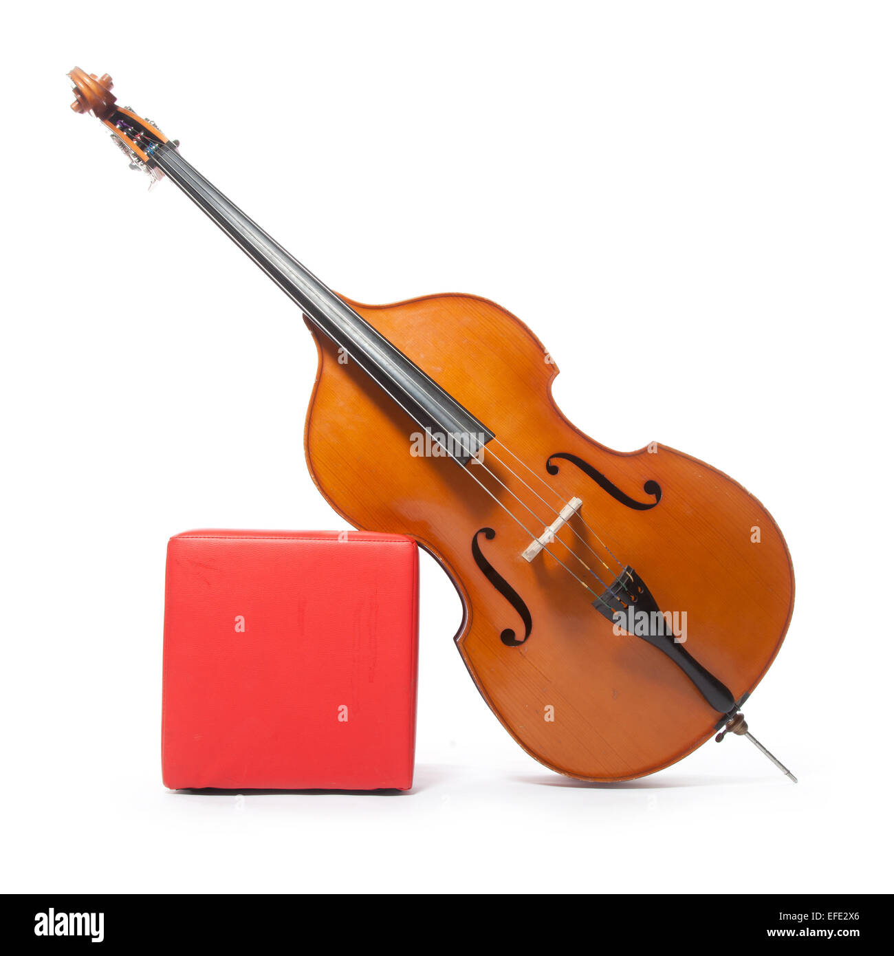 double bass leans against red box in studio with white background Stock Photo