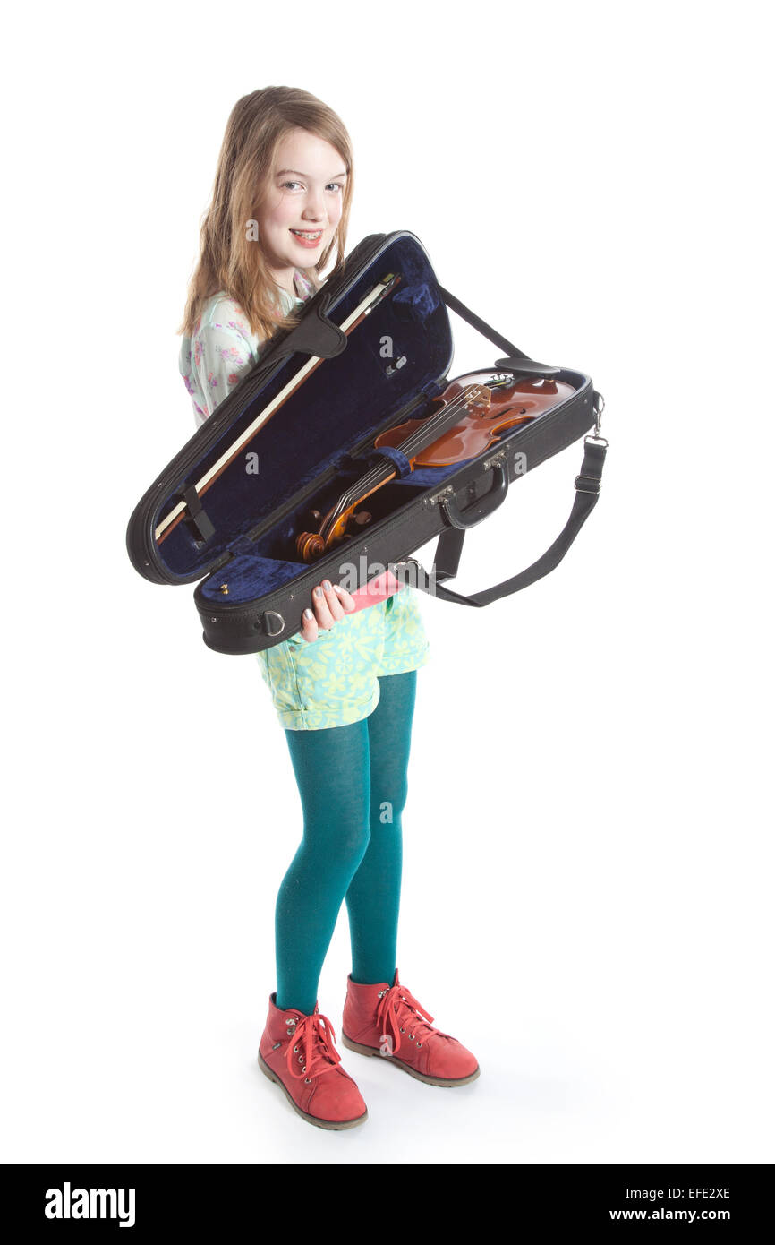 young girl stands in studio against white background with violin in ...