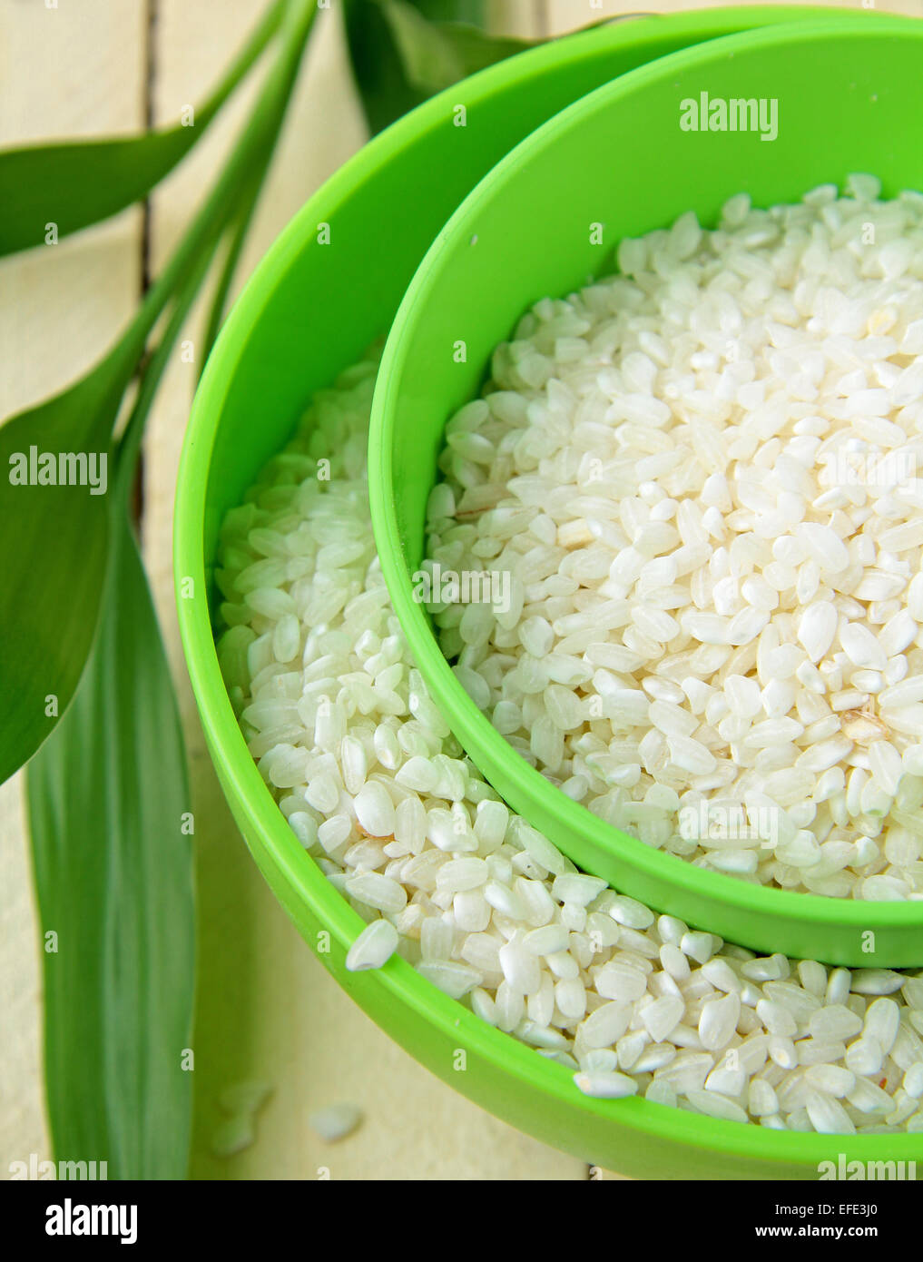 natural organic white rice in bowl on a wooden background Stock Photo