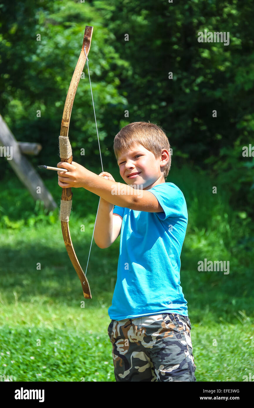 The kid shoots a bow in the park Stock Photo Alamy